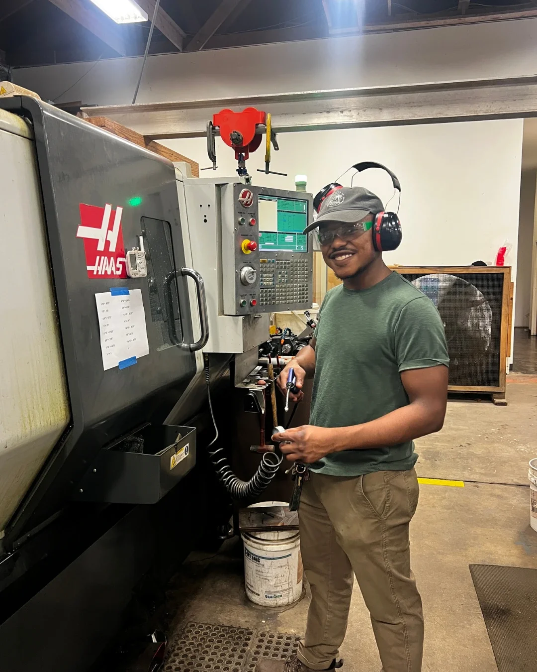 A machA machinist leading a production manufacturing run at Tektonics Design Group in Richmond, Virginia, where designers and machinists work together on solutions for clients.