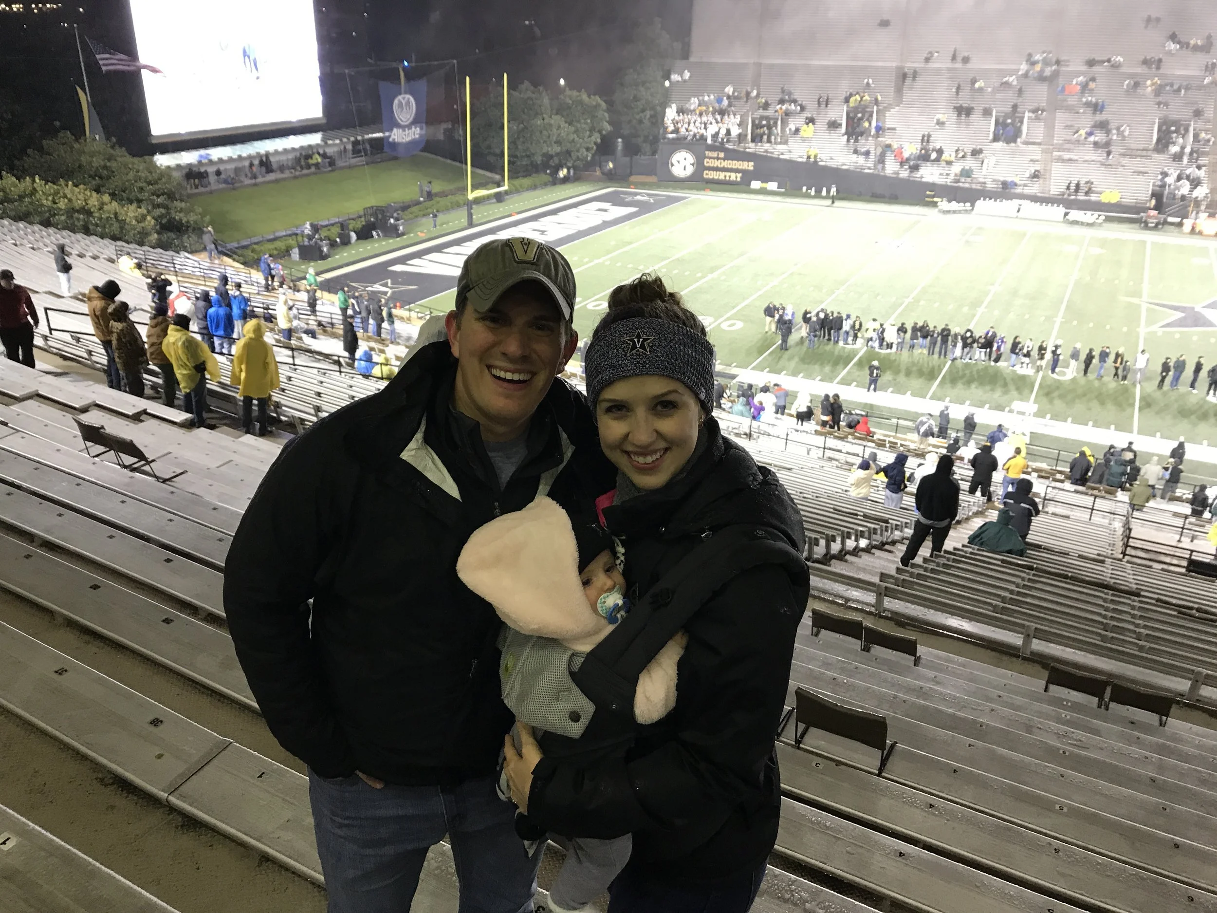Nick, Lauren, and their daughter survive a cold and rainy football game at Vanderbilt. 