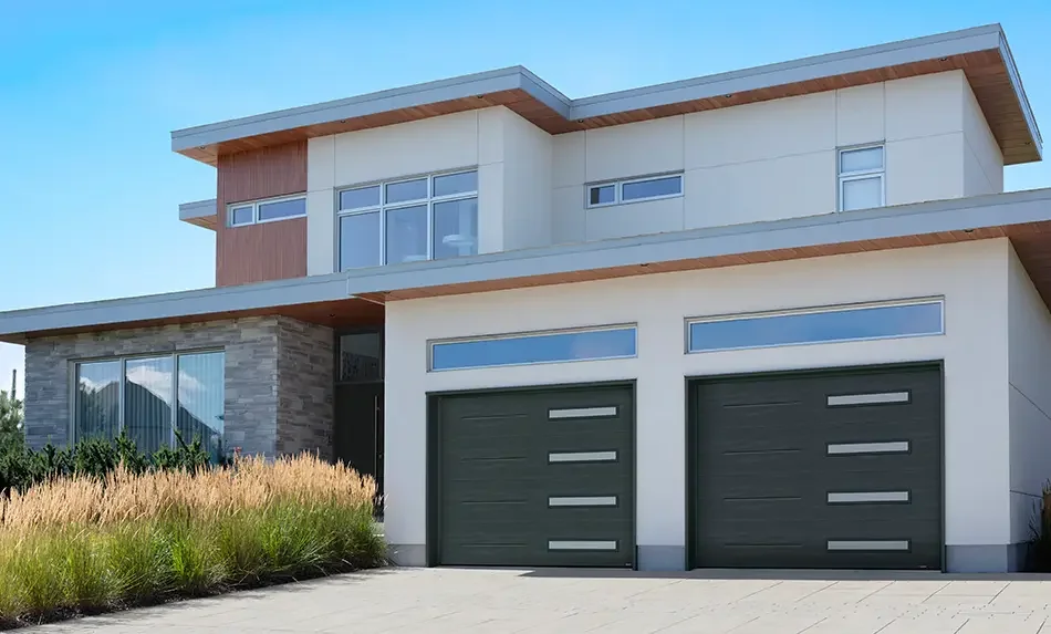 Modern two-story home with two dark garage doors featuring horizontal windows