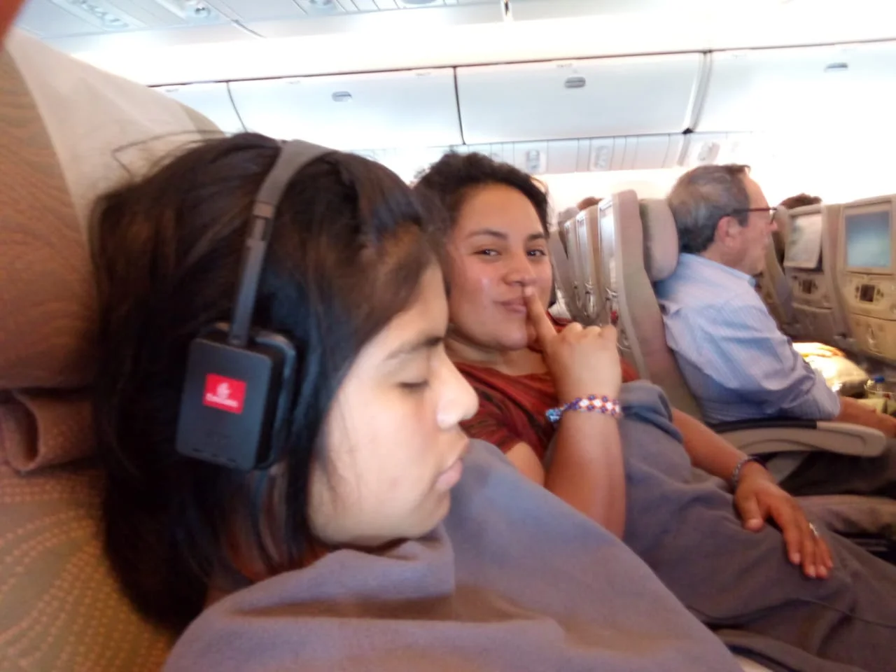 Ester finally getting some sleep on the plane, with Vilma in the background. Photo: Lidia Oxi