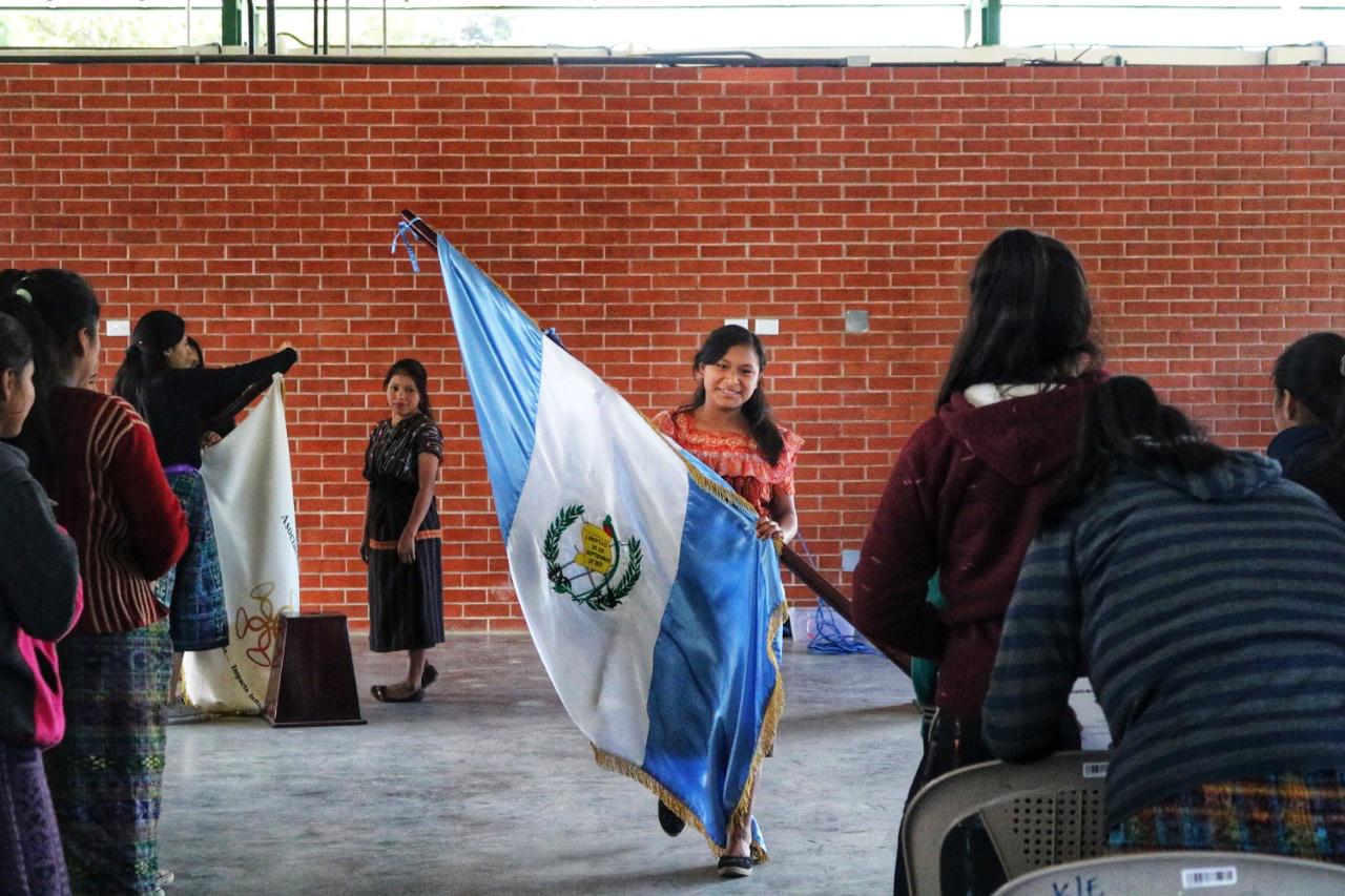 Girl Pioneers during the Student Government Inauguration carrying the Guatemalan Flag