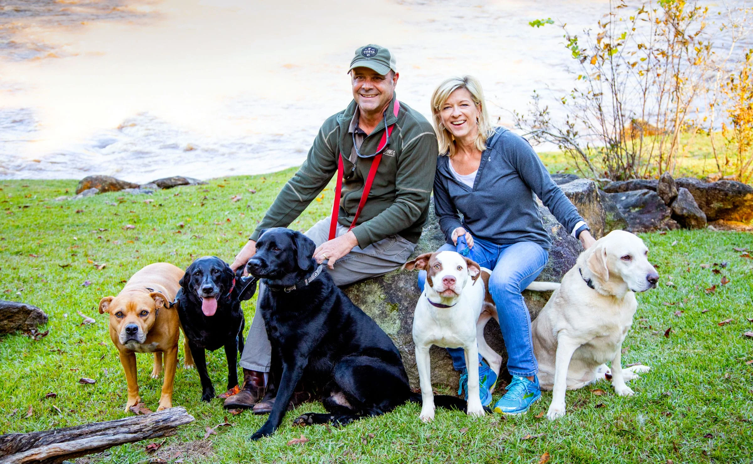 Holly and her husband Scott with their four rescues and one foster