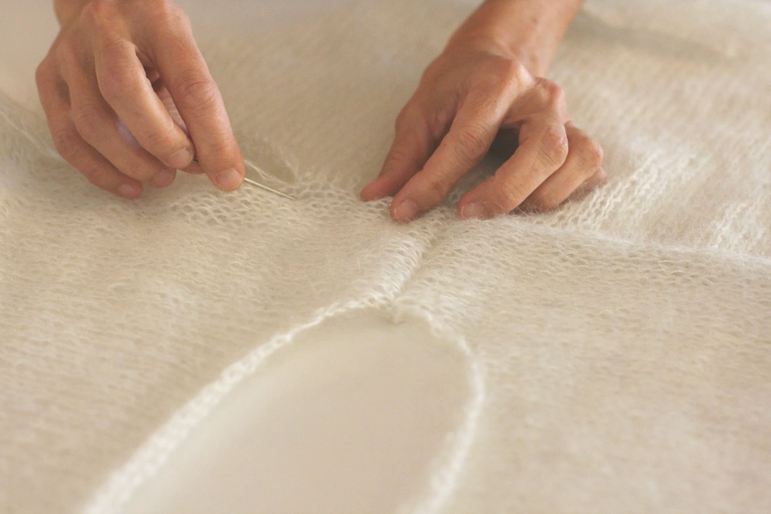 Proces of hand knitting and sewing pullover seams