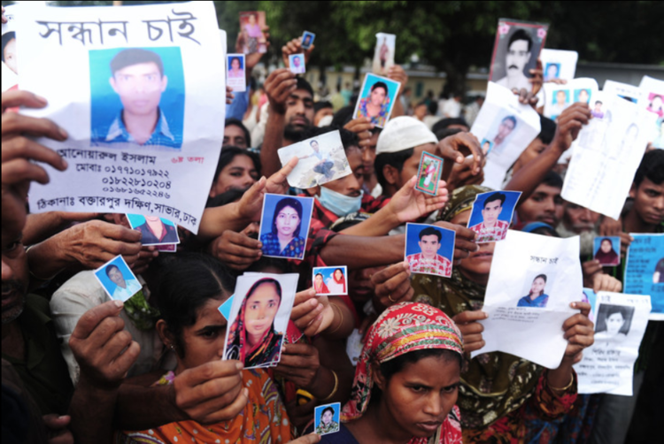 Bangladeshi relatives hold photos of missing and dead workers. AFP/Getty Images