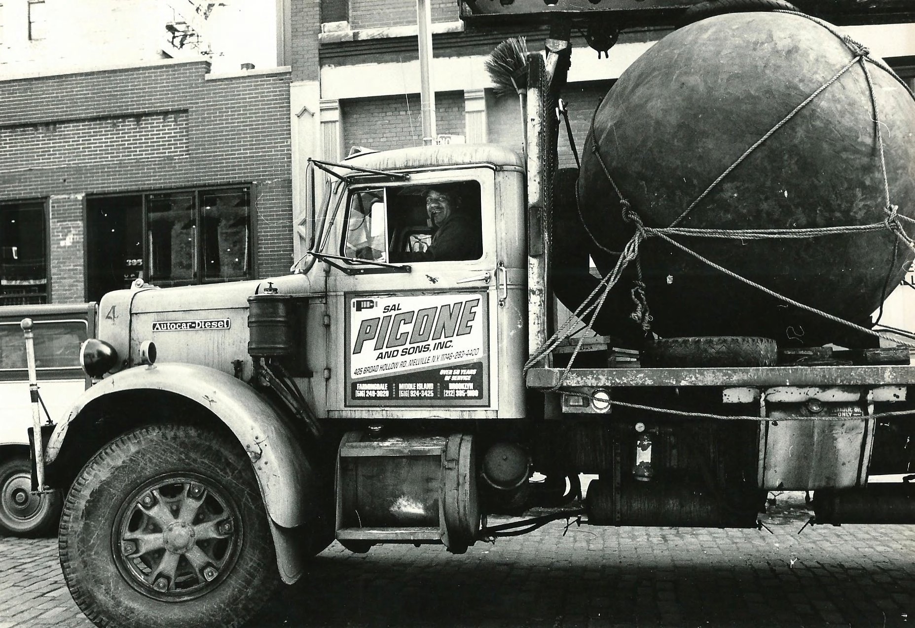 Photograph of Black Sphere being transported via truck