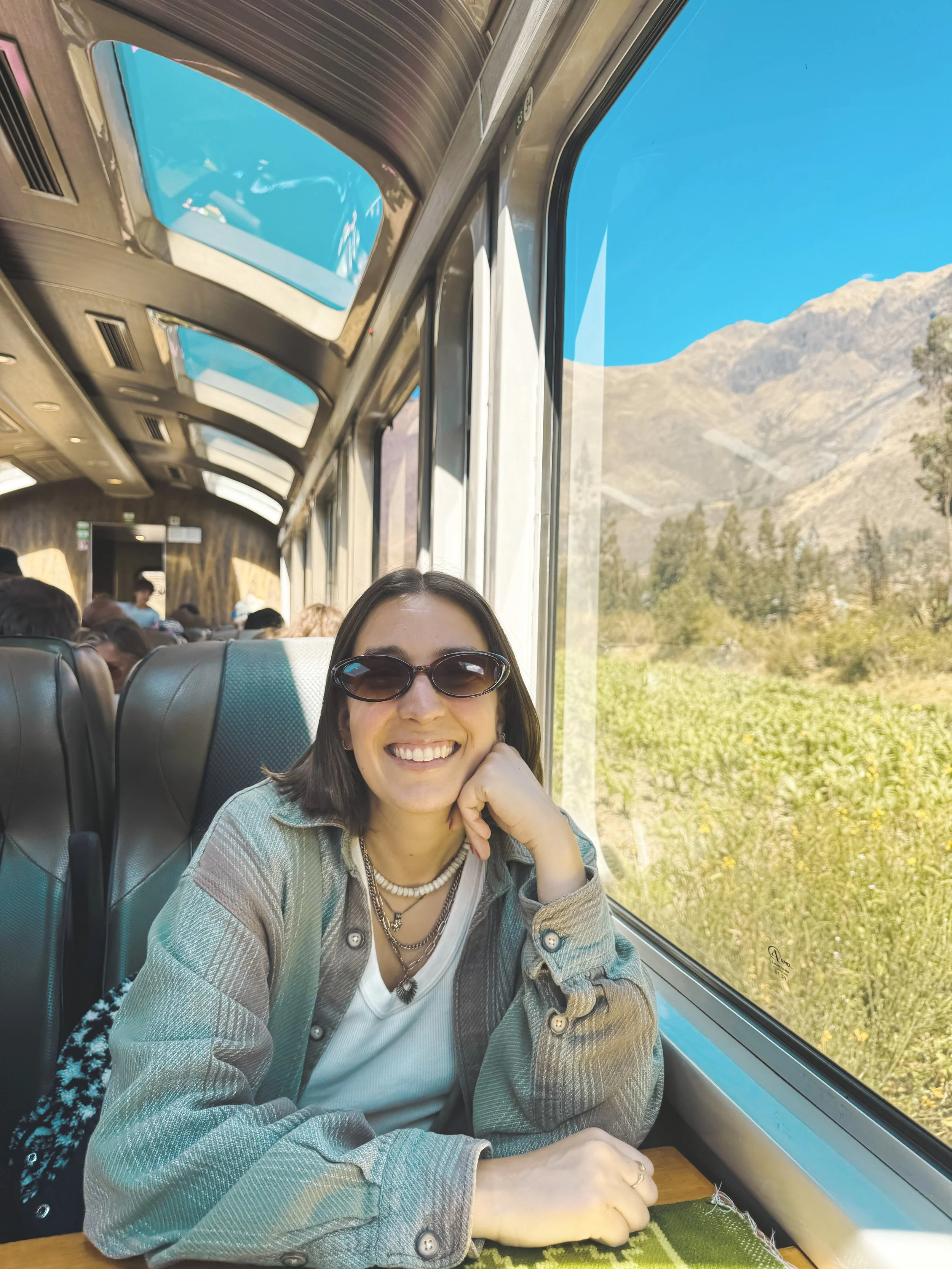girl sitting on perurail train from cusco to machu picchu