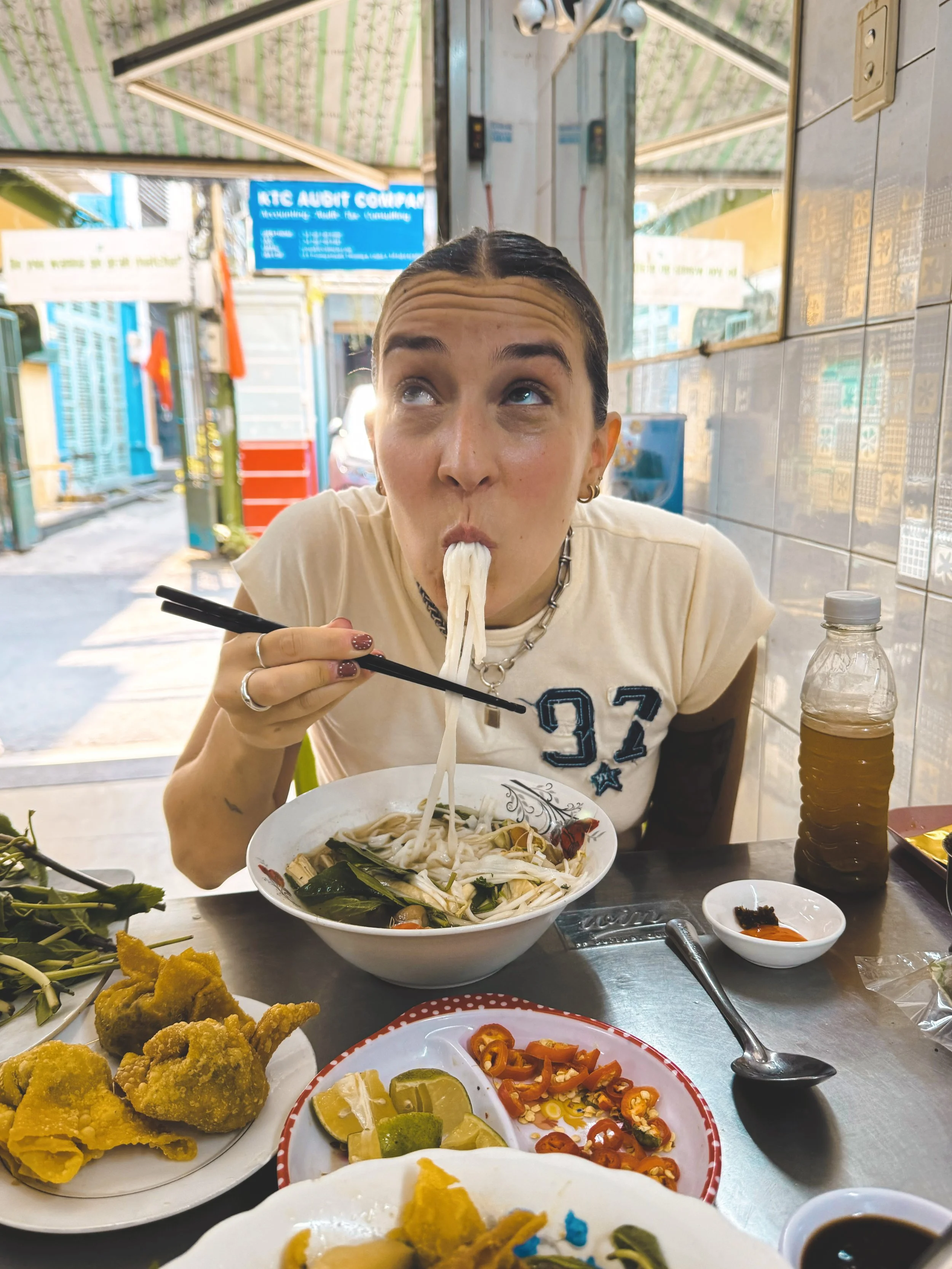 girl eating pho in ho chi minh city