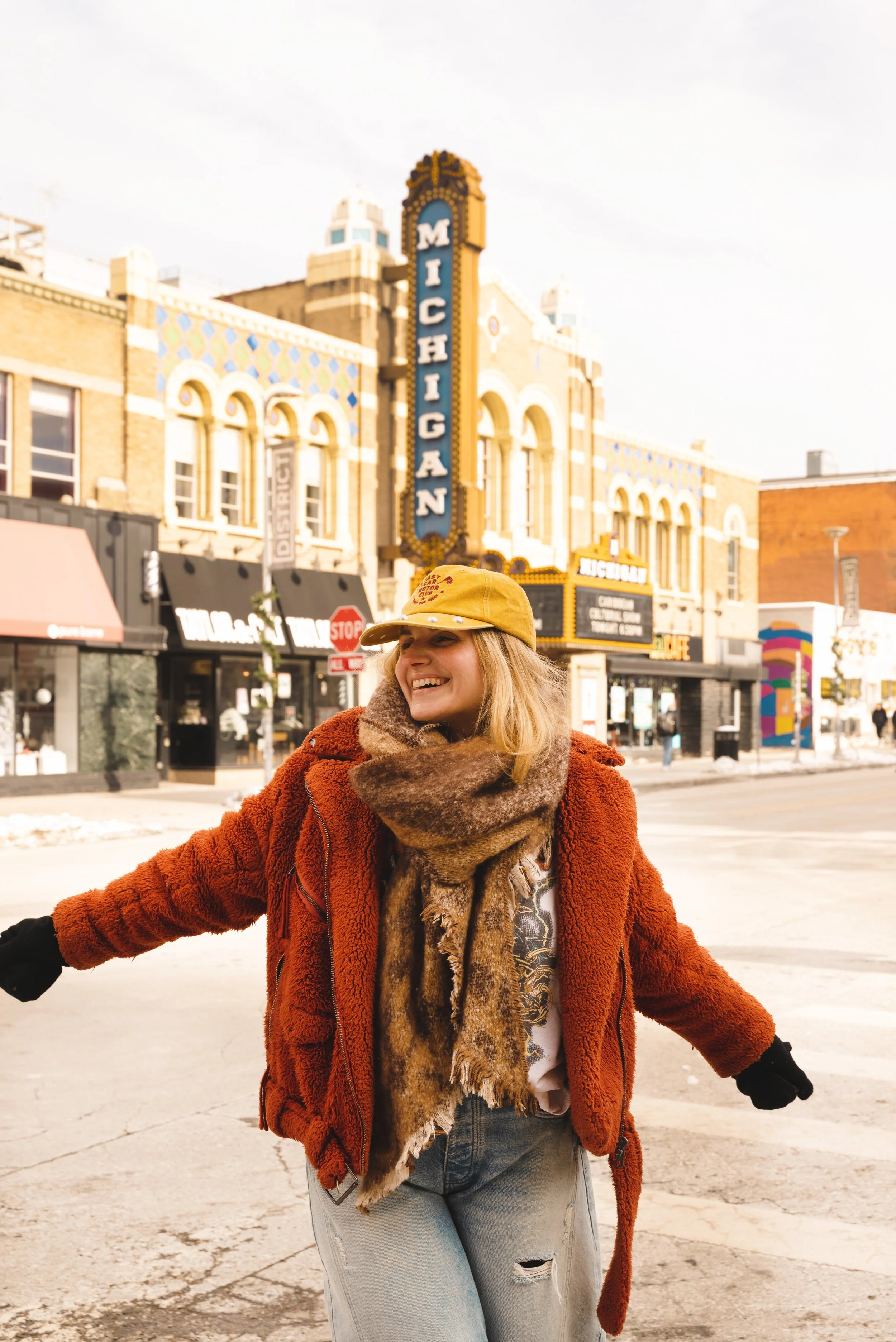 girl smiling in front if michigan theater ann arbor
