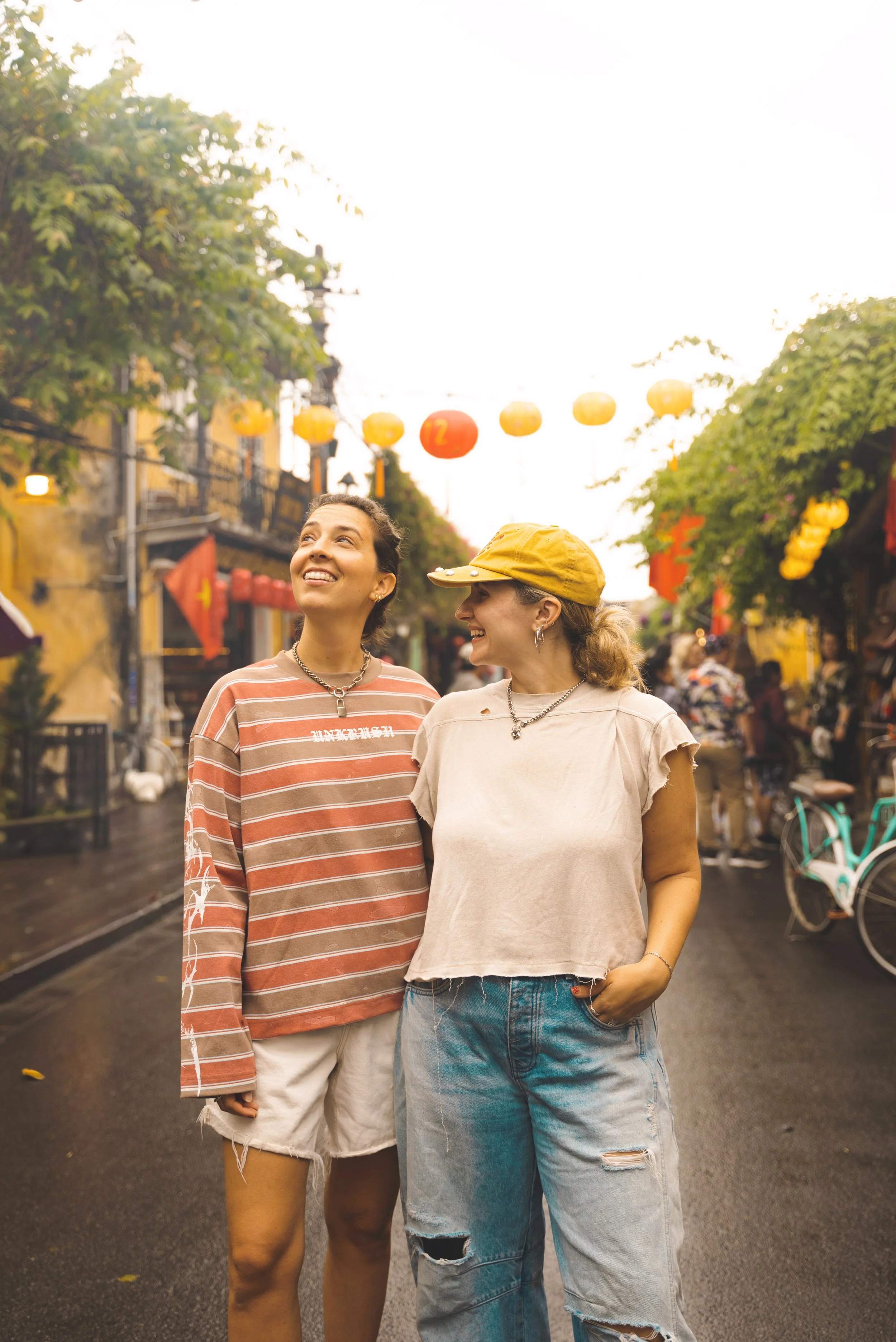 two girls under lanterns in hoi an ancient town vietnam