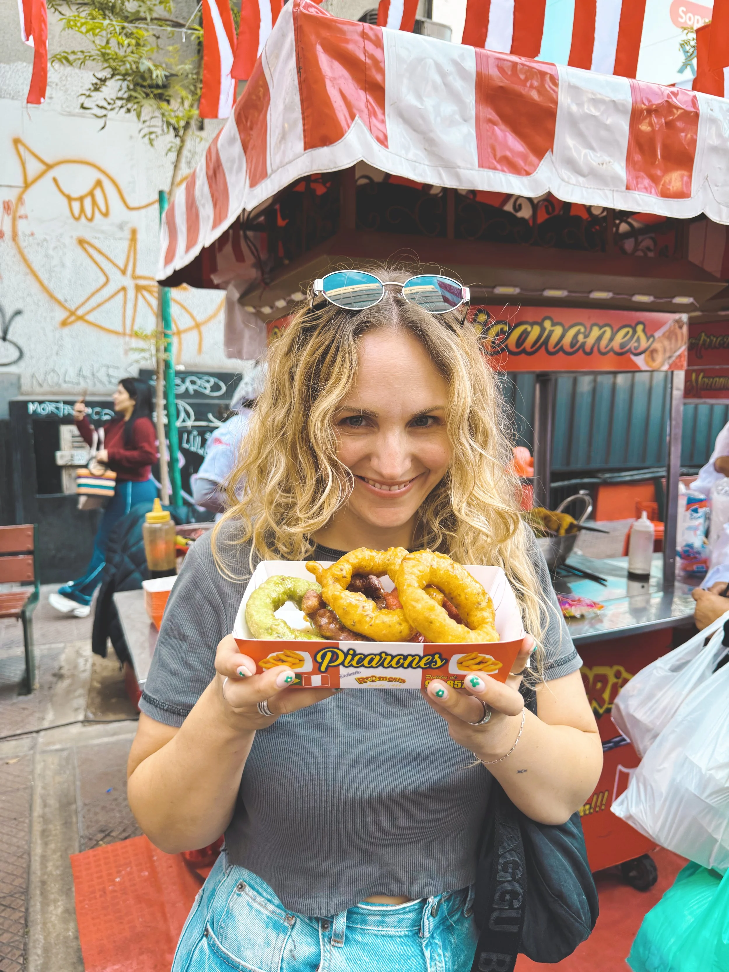 girl holding picarones lima peru