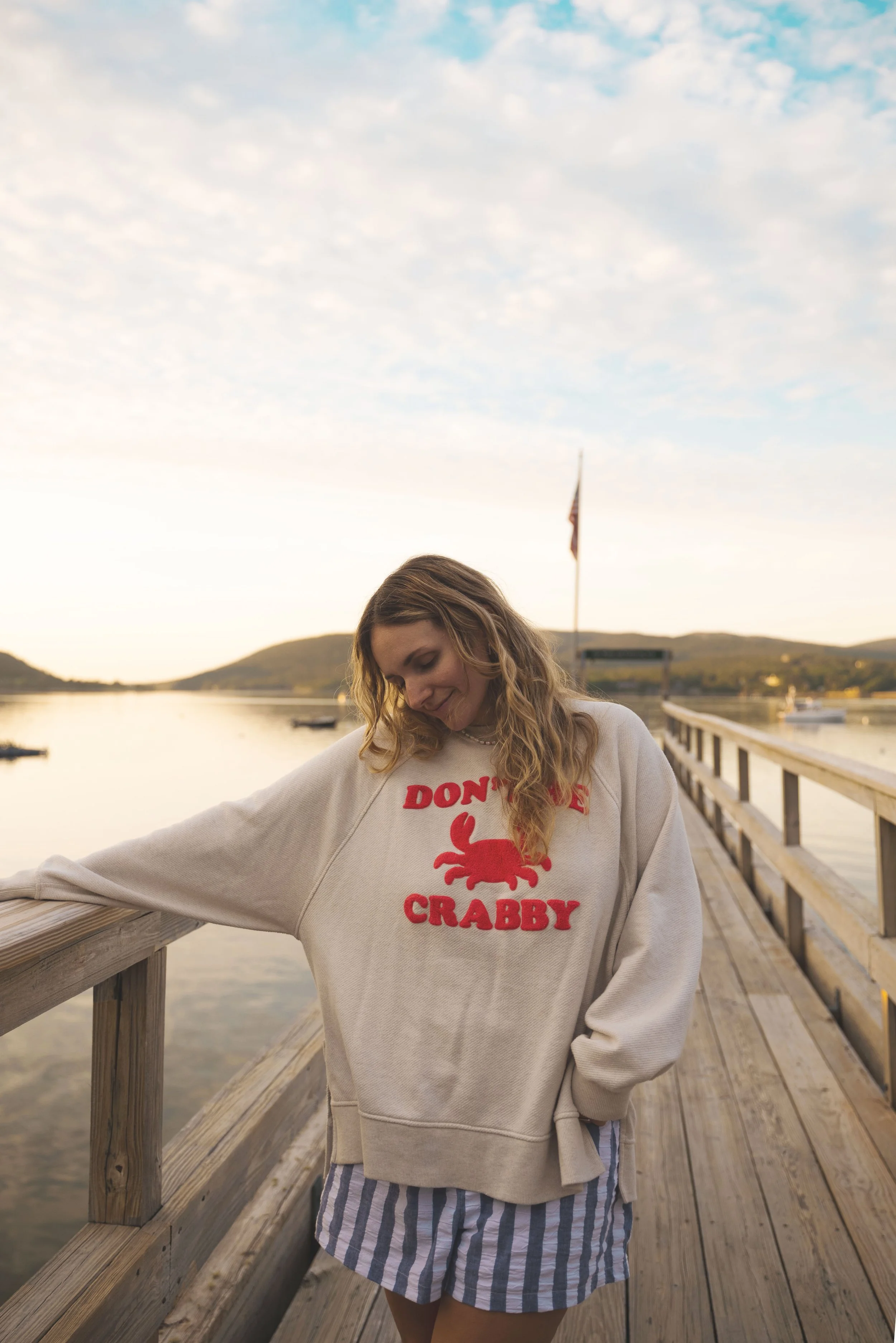 girl at sunset on dock in bar harbor maine