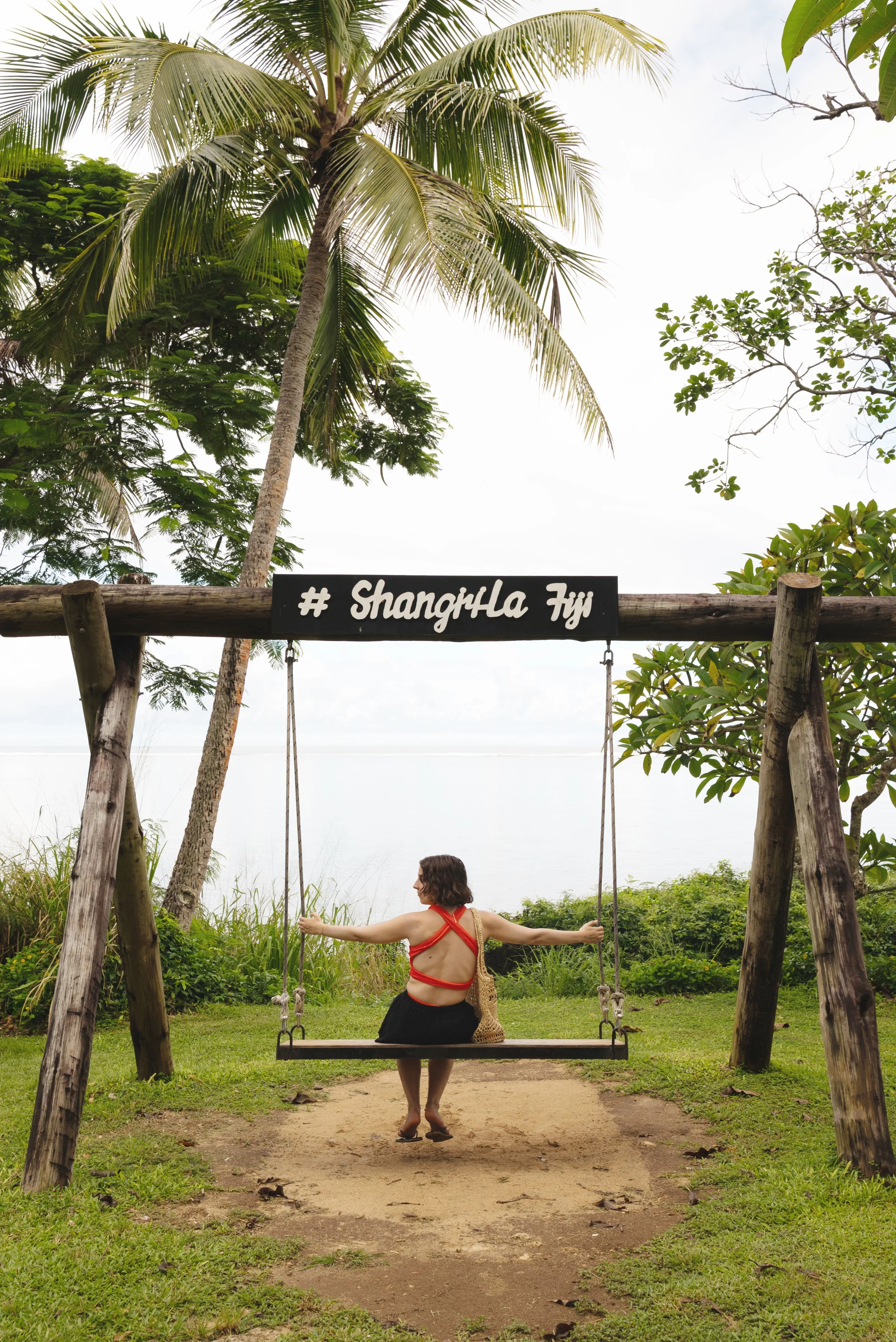 girl sitting in swing at shangri la yanuca island fiji