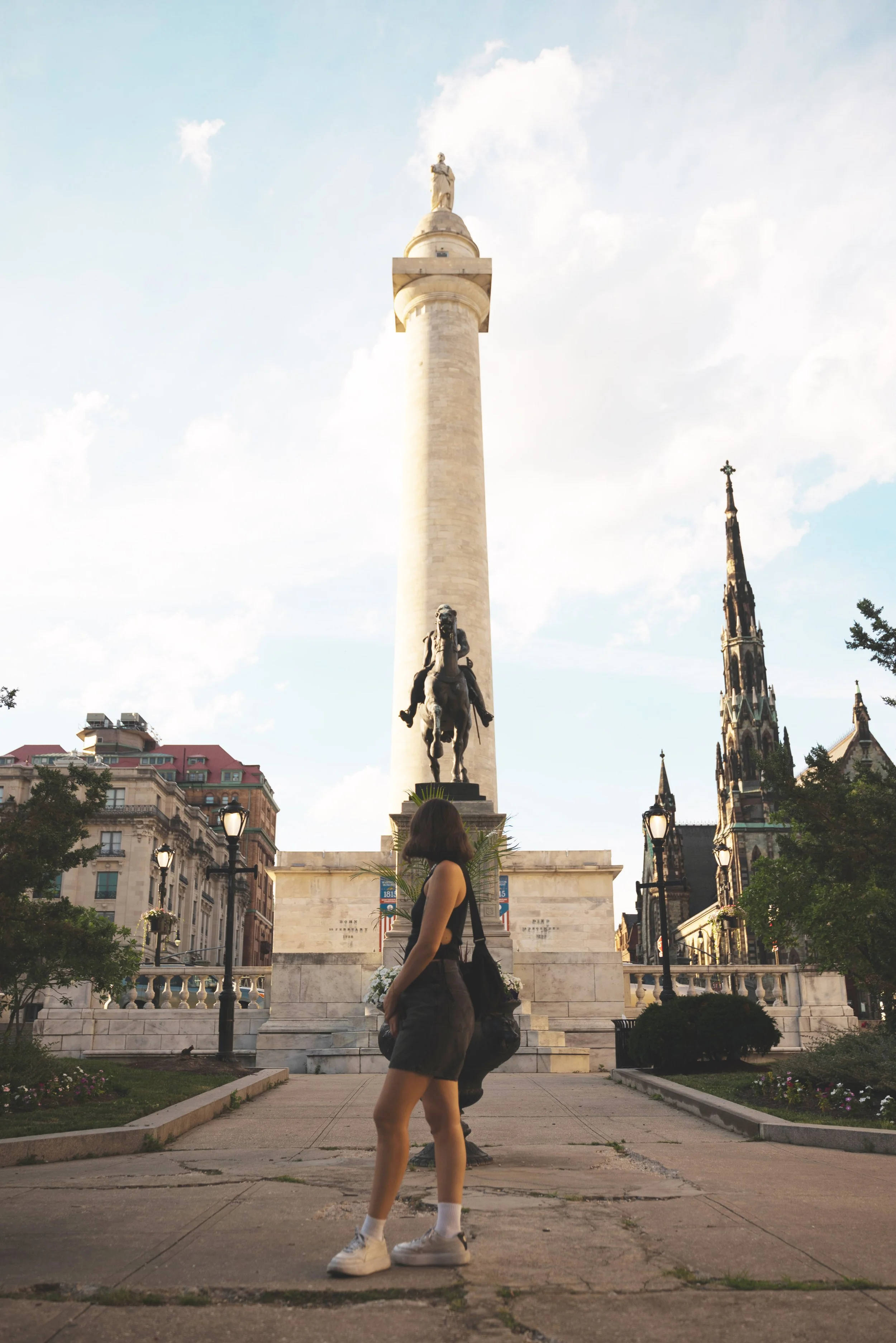 girl standing in front of washington monument baltimore