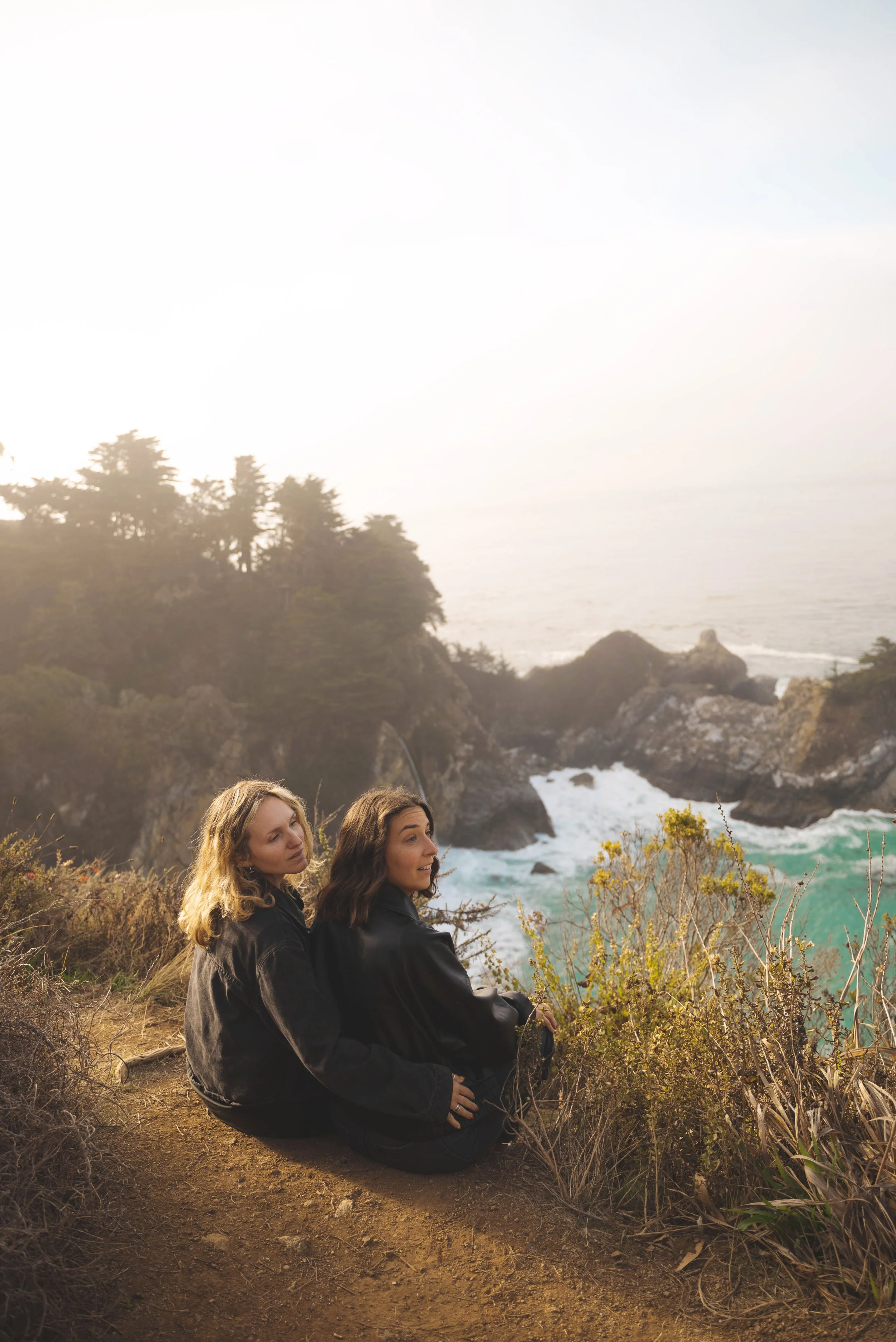 two girls sitting looking at mcway falls california