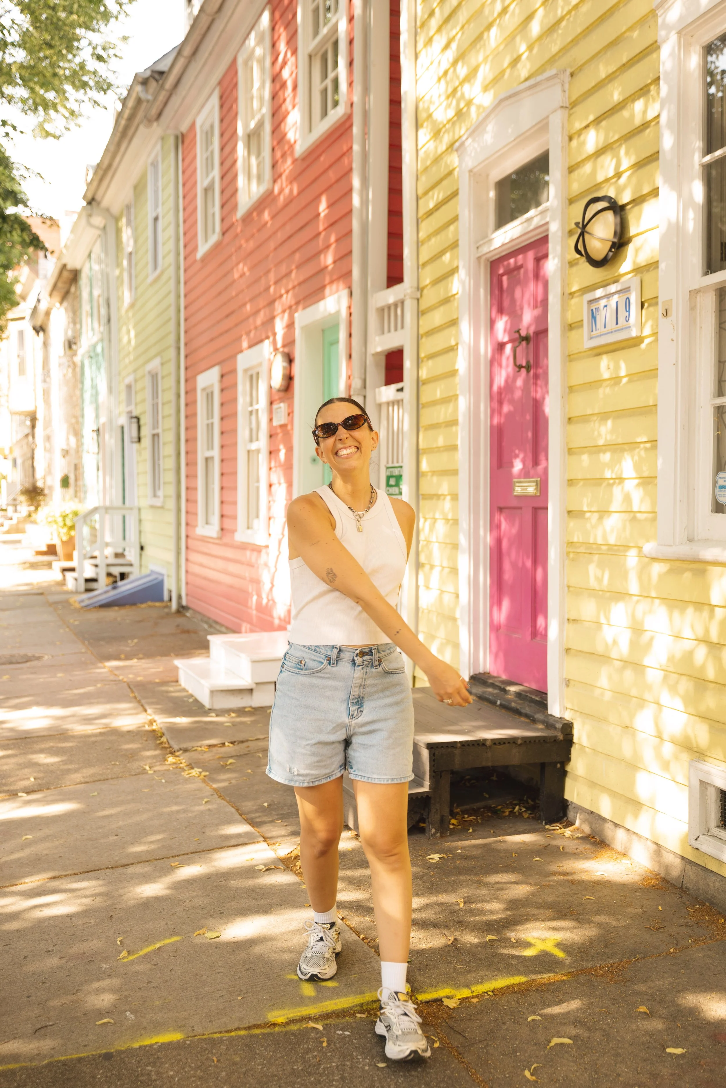 girl walking past colorful houses in fell's point baltimore