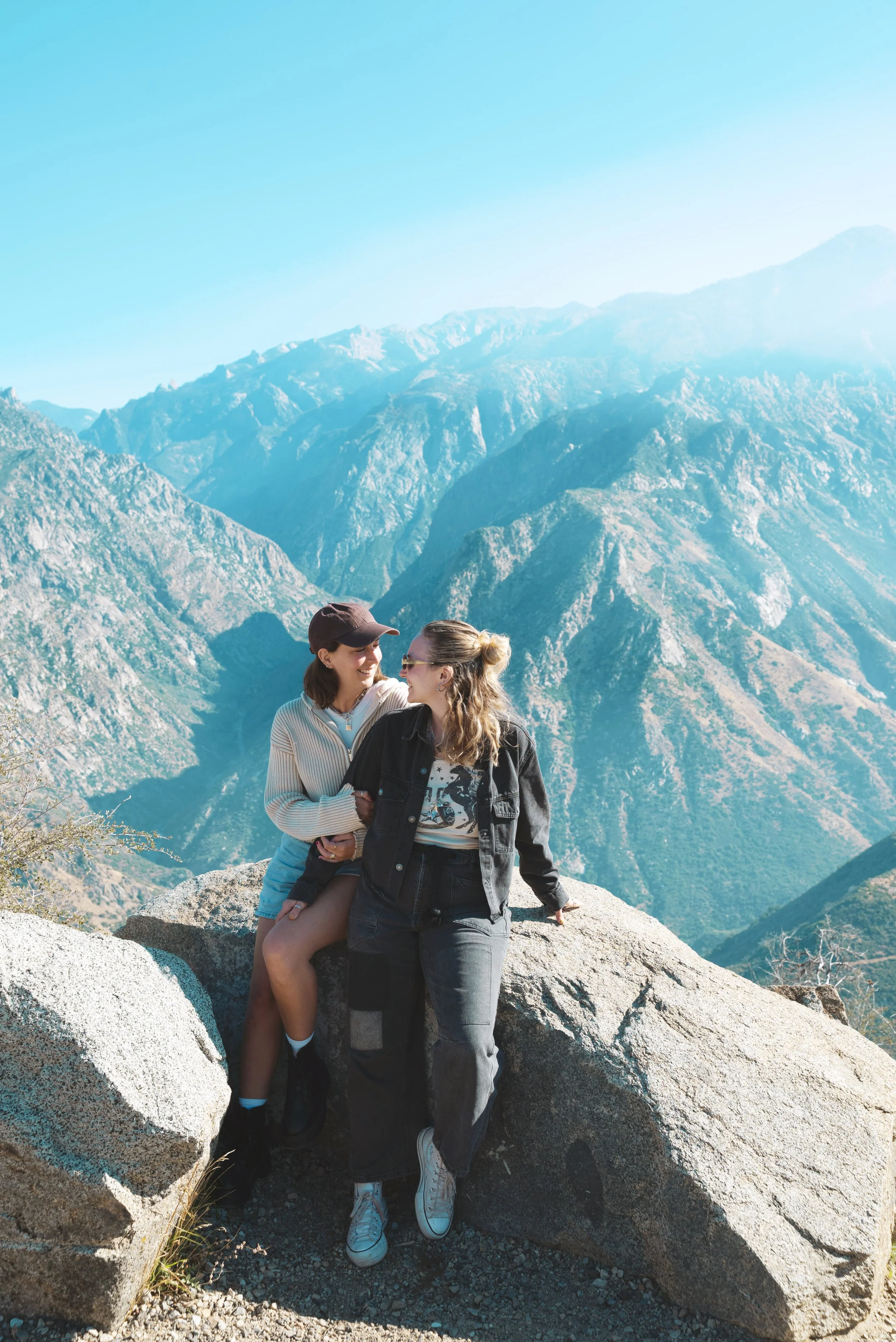 two girls sitting on a rock in kings canyon national park california