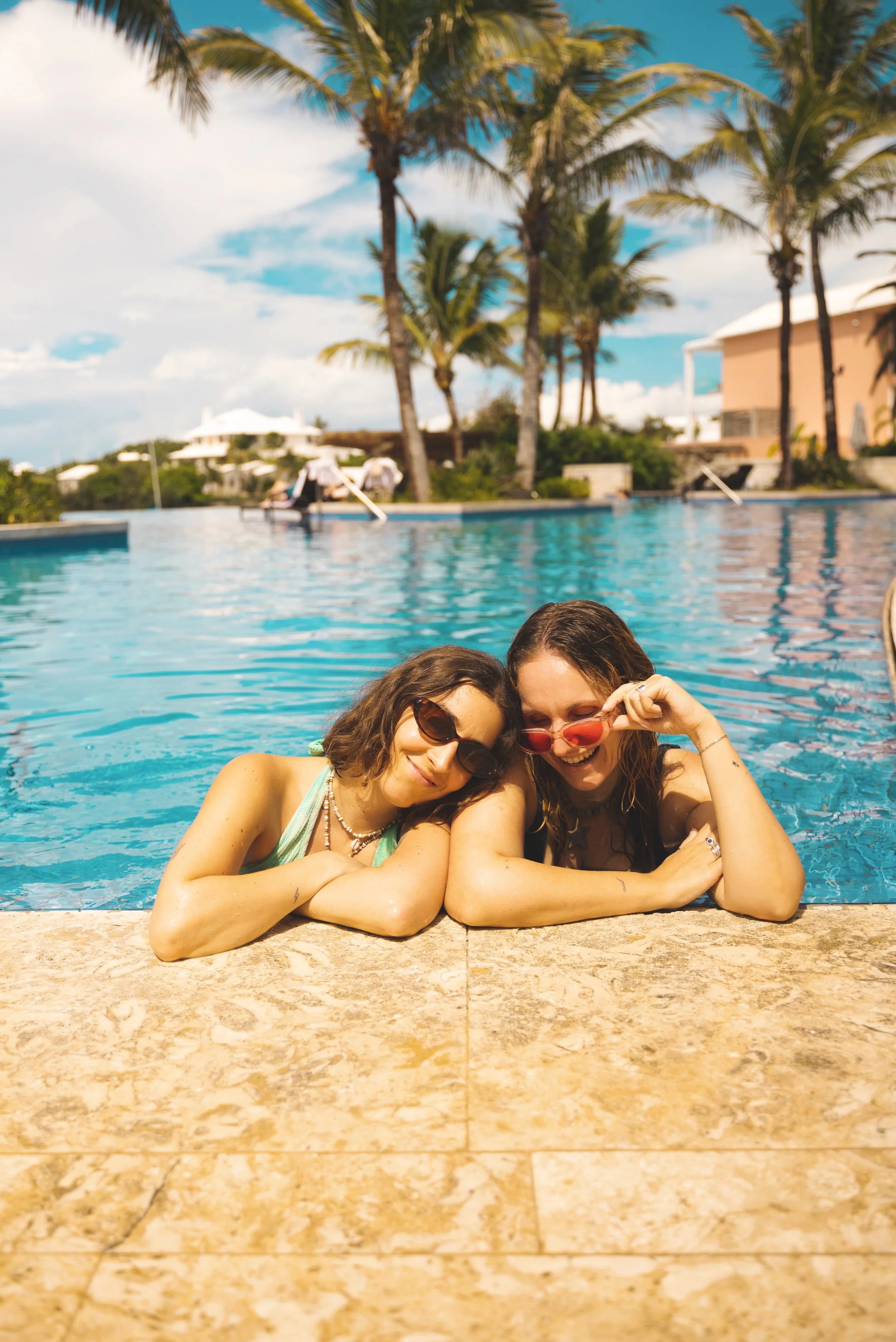 two girls sitting in hamilton princess bermuda infinity pool