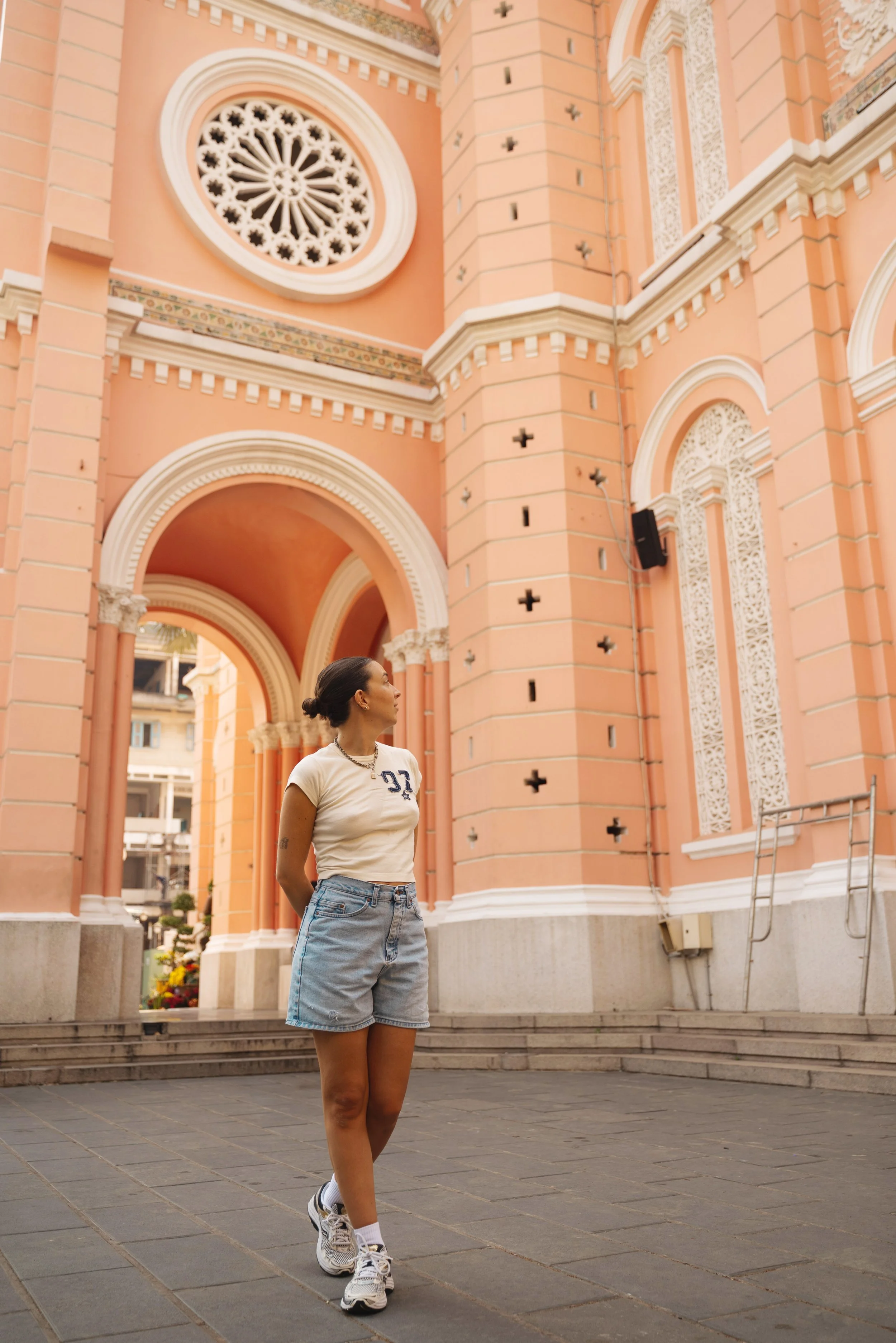girl standing in front of tan dinh pink church saigon