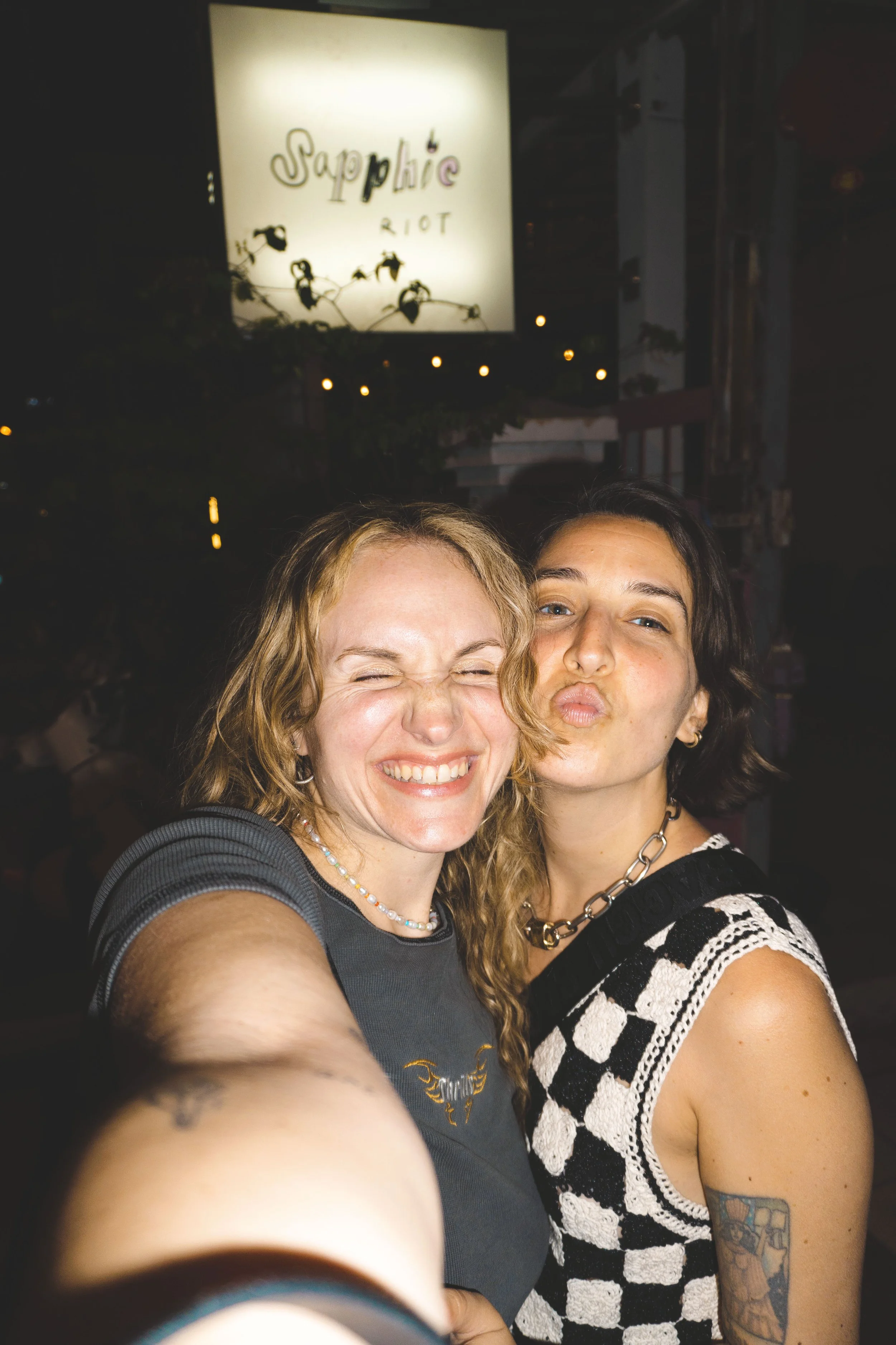 two girls standing outside sapphic riot chiang mai