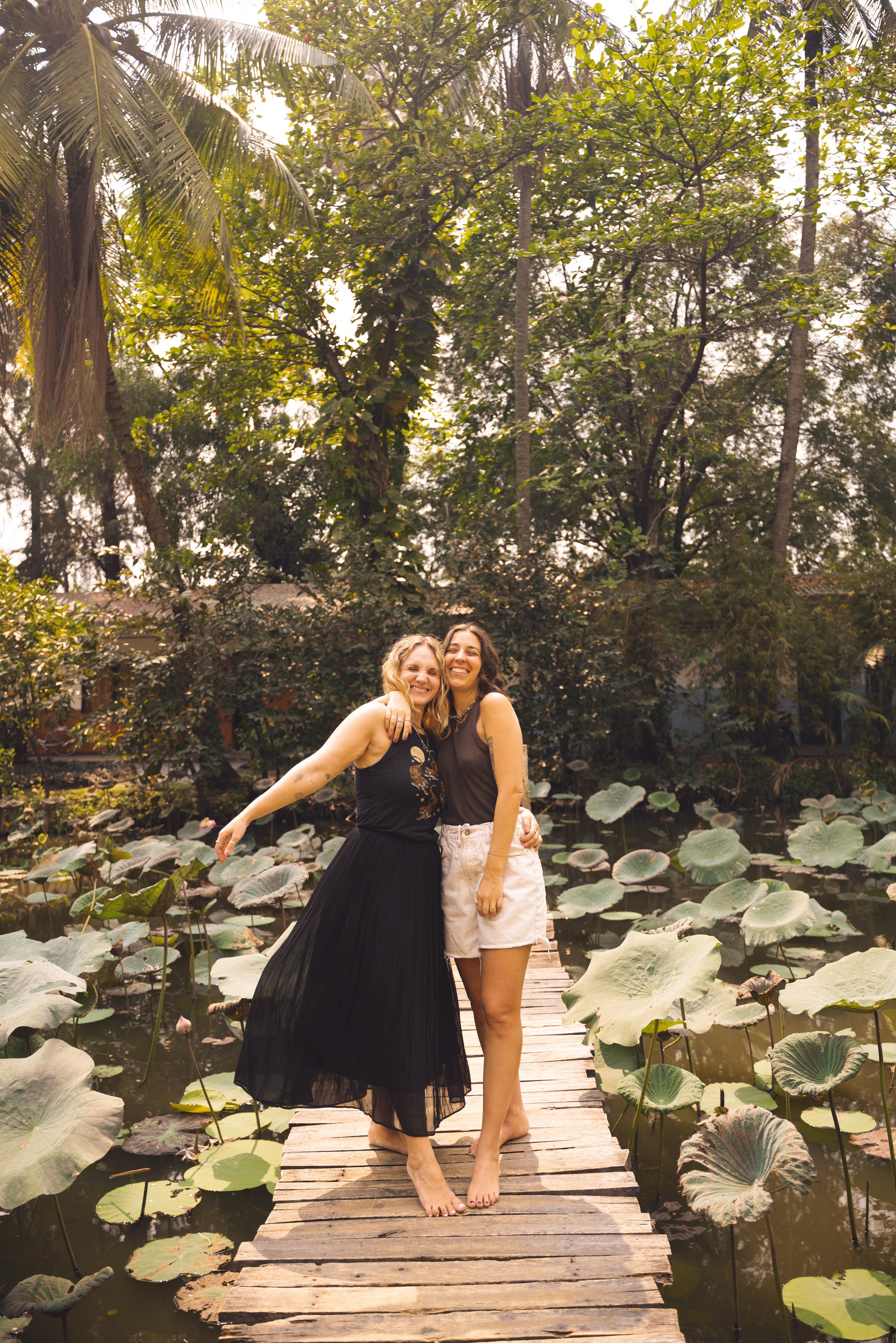 two girls in bihn quoi tourist village lily pond hcmc vietnam