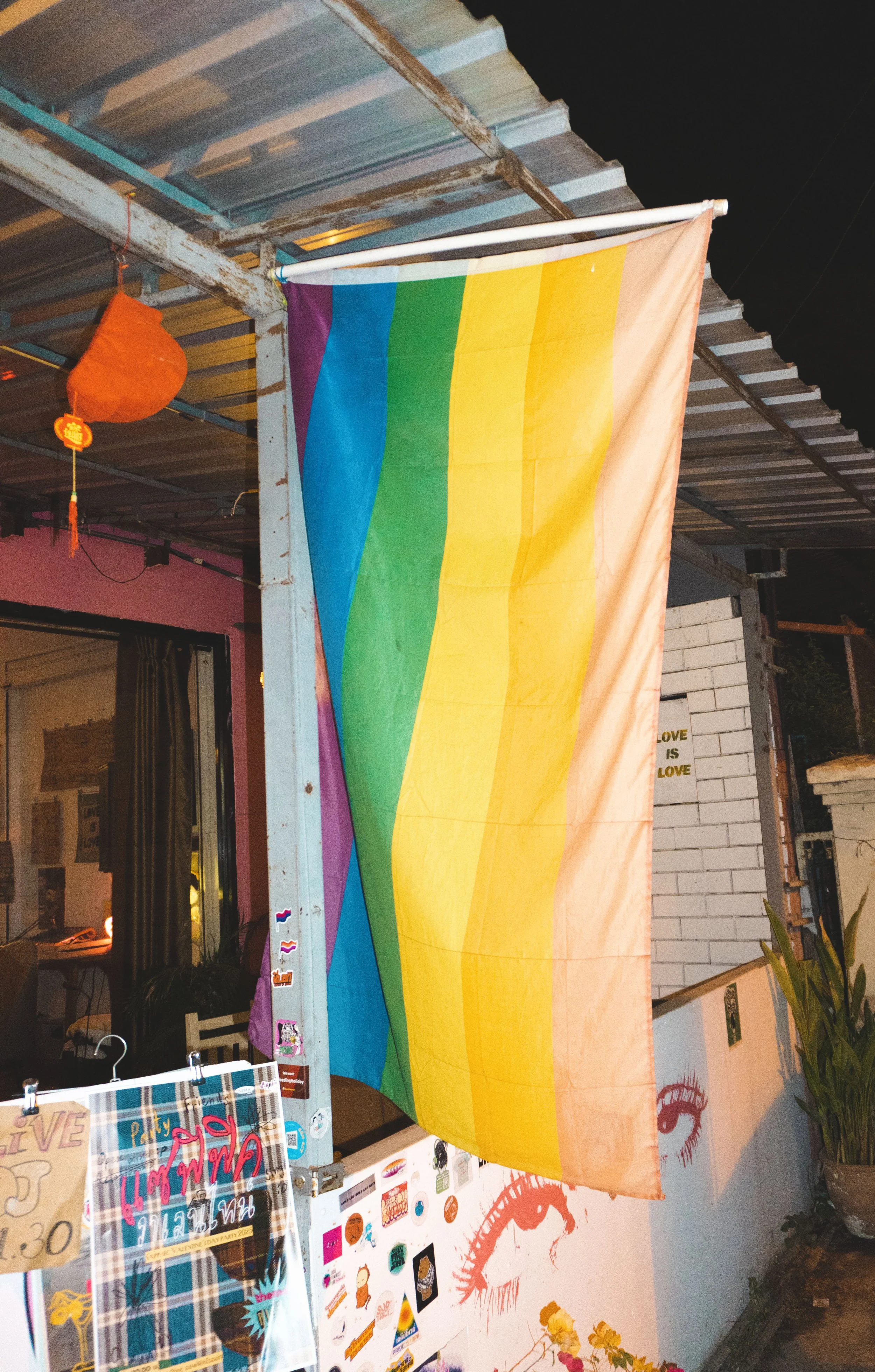 pride flag outside sapphic riot chiang mai