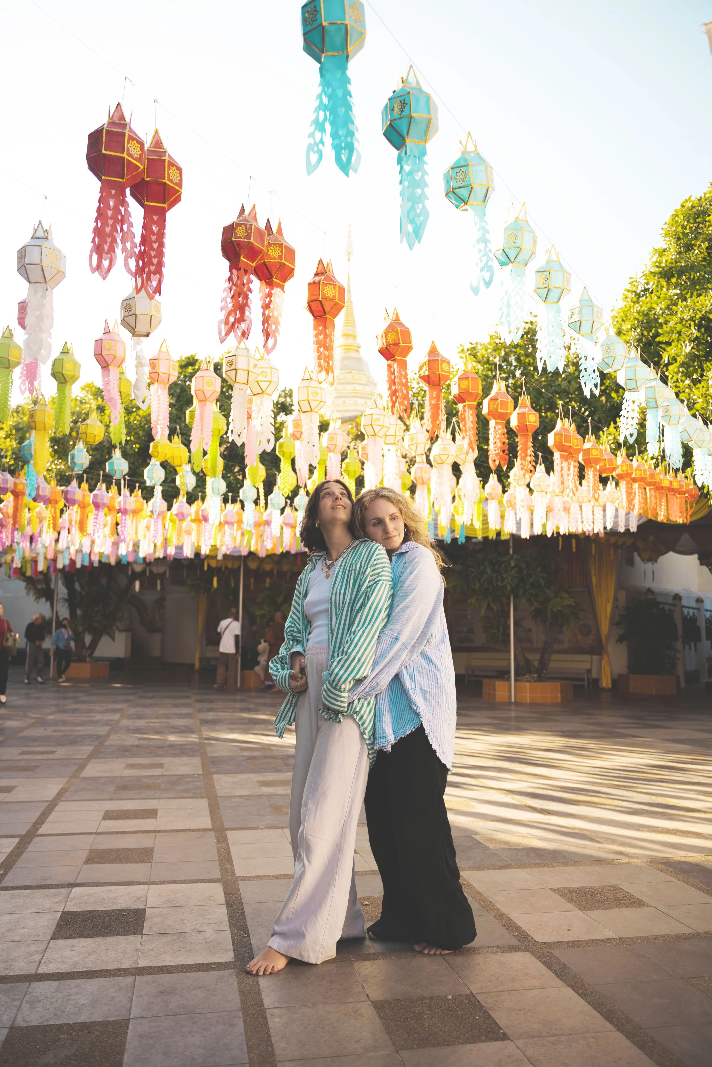 two girls standing under colorful lanterns at Wat Phra That Doi Suthep chiang mai