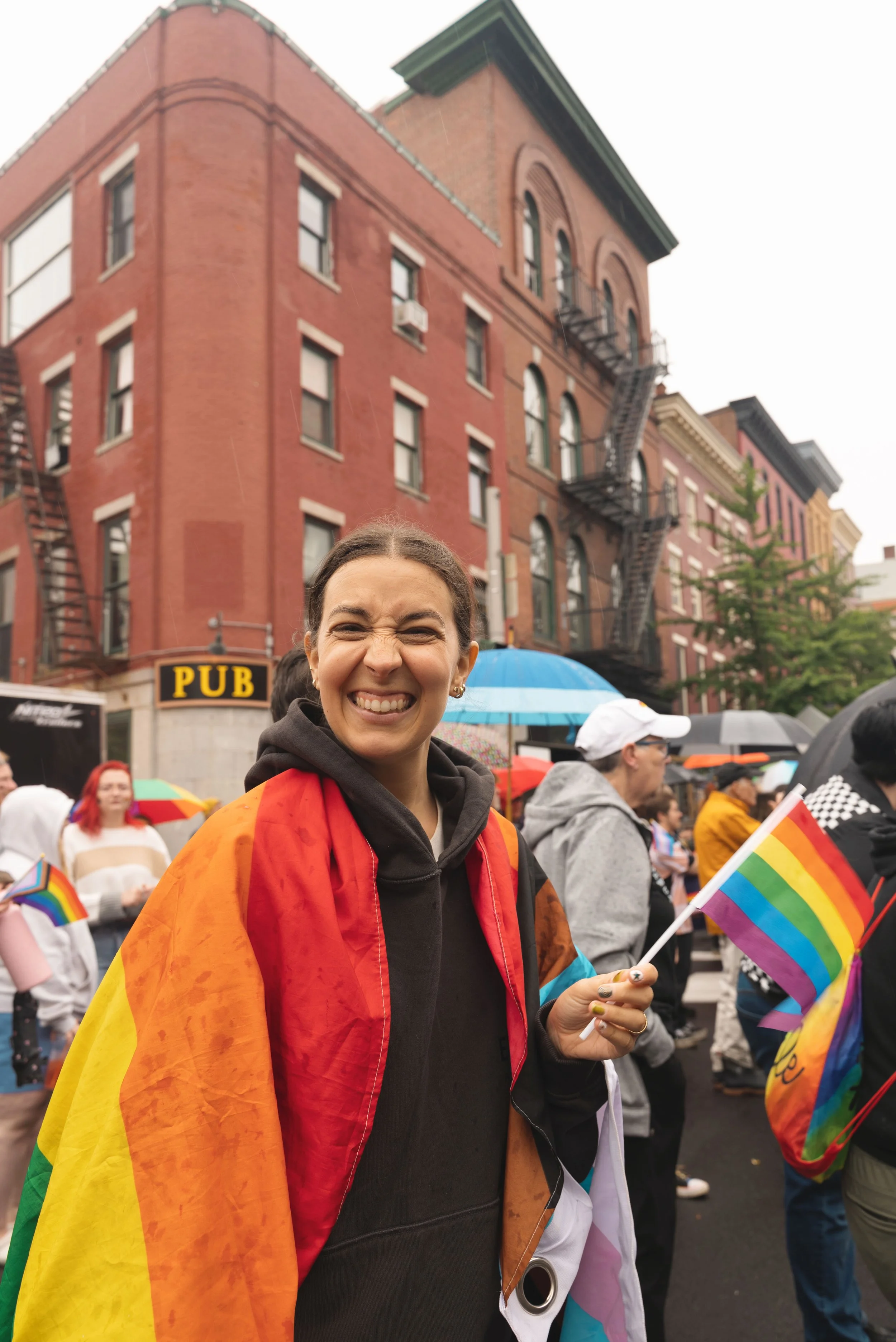 girl holding rainbow flag at bangor pride