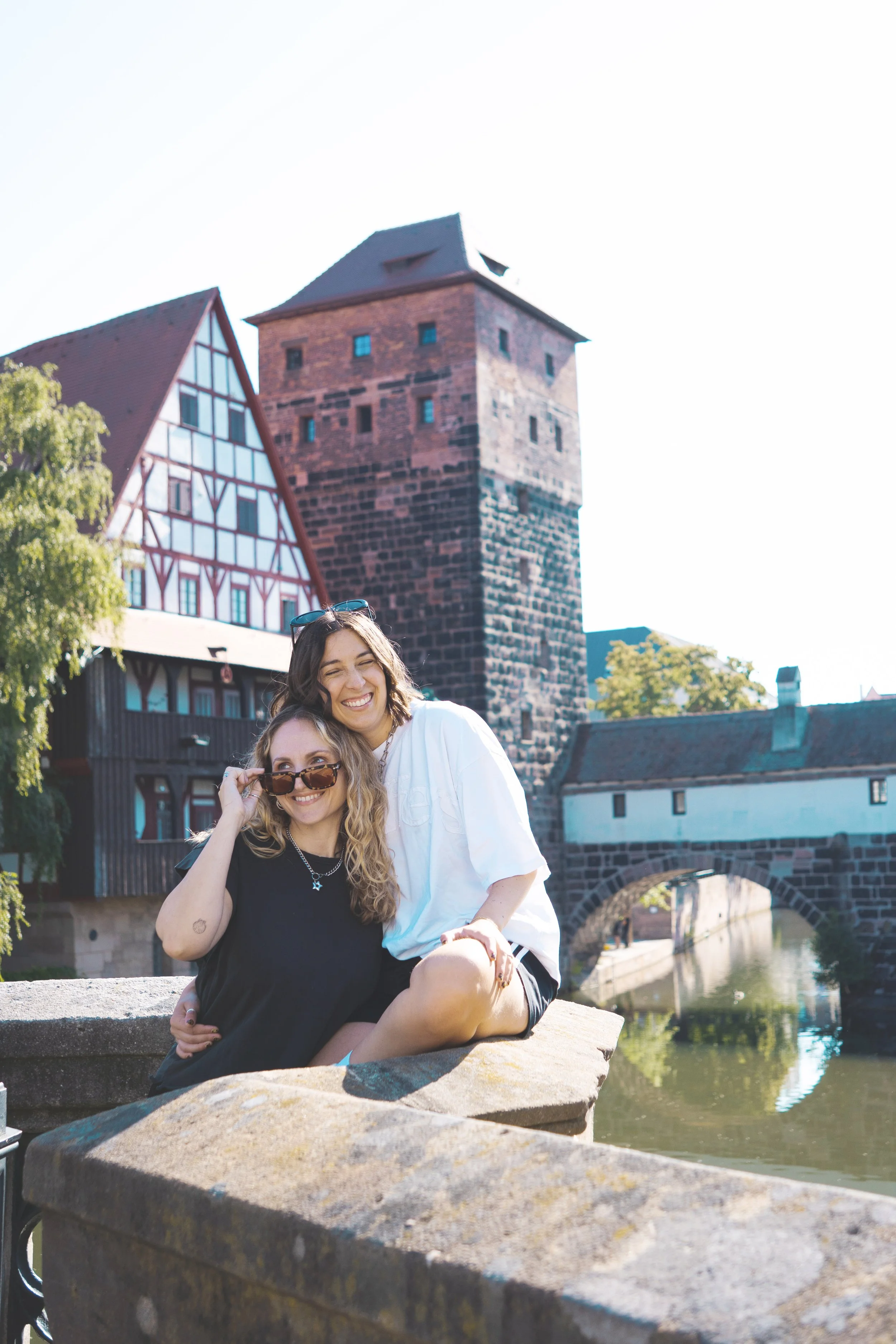 girls sitting on bridge overlooking Hangman's Bridge Nuremberg