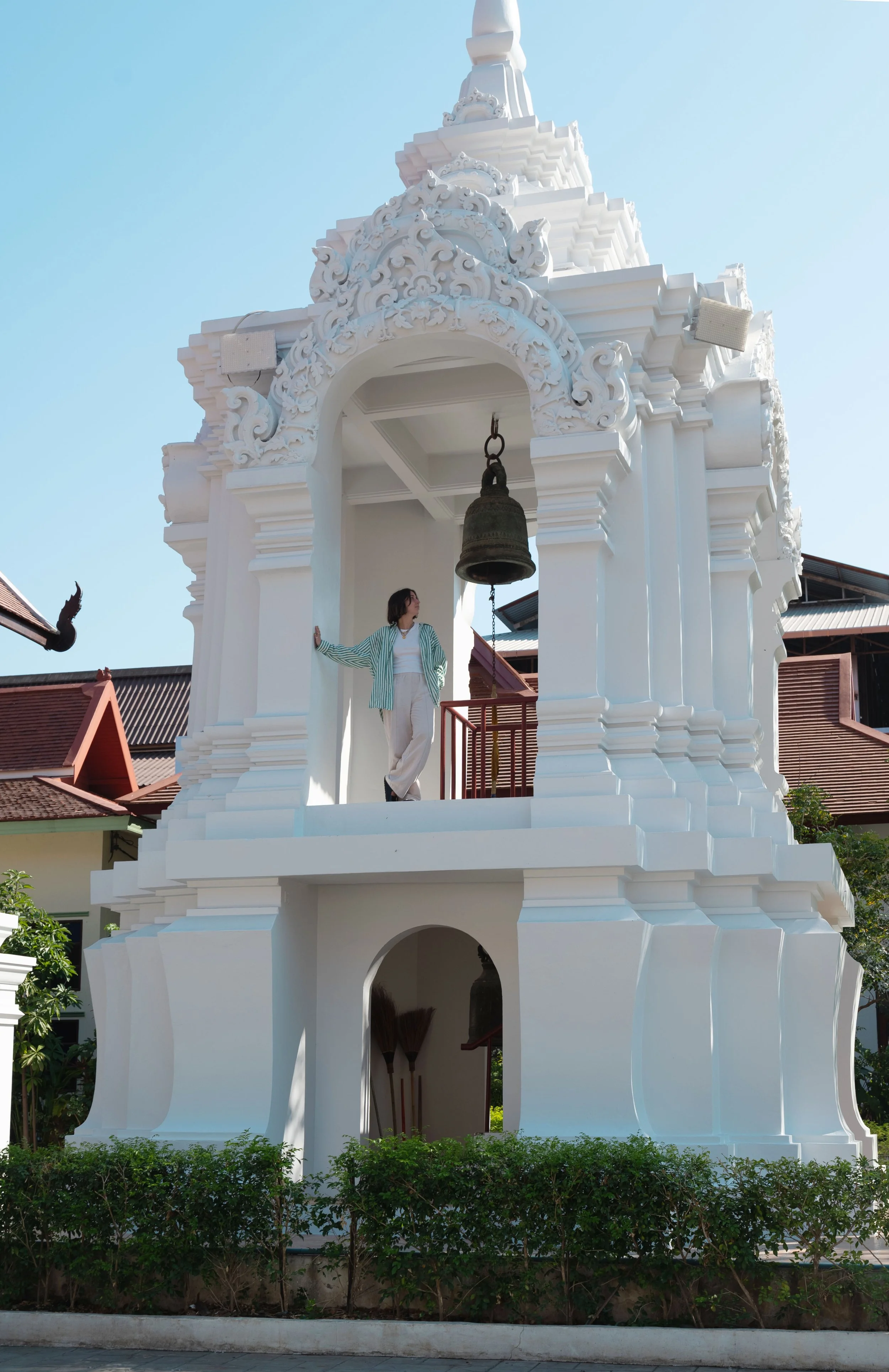 girl standing in bell tower of Watchediuang Varaviharn Temple chiang mai
