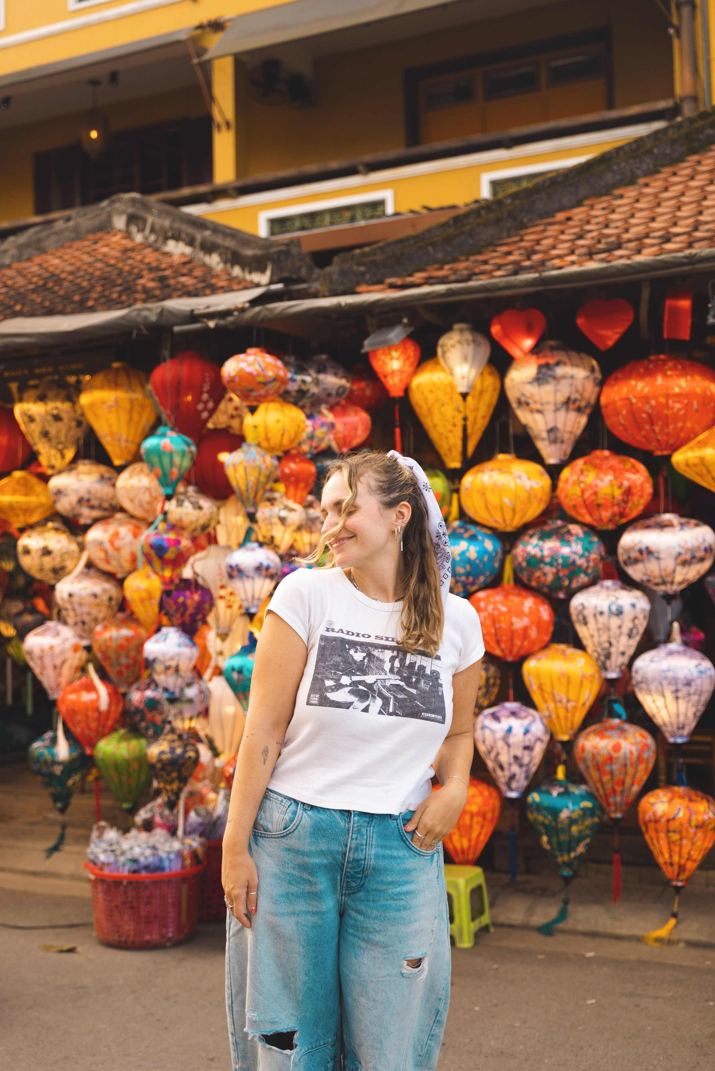 girl standing in front of colorful lanterns in hoi an vietnam