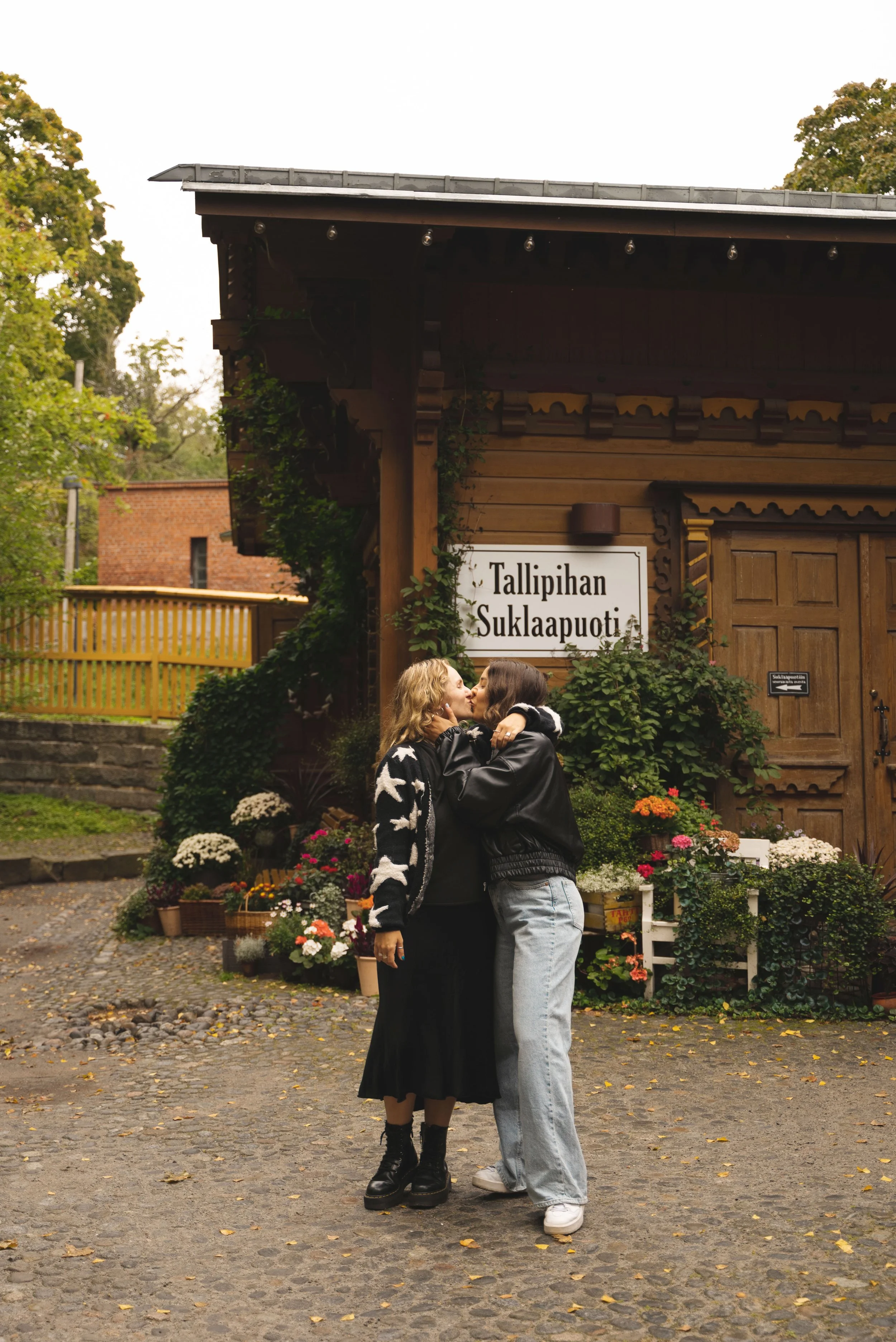 two girls kissing in tallipihan stable yard tampere finland