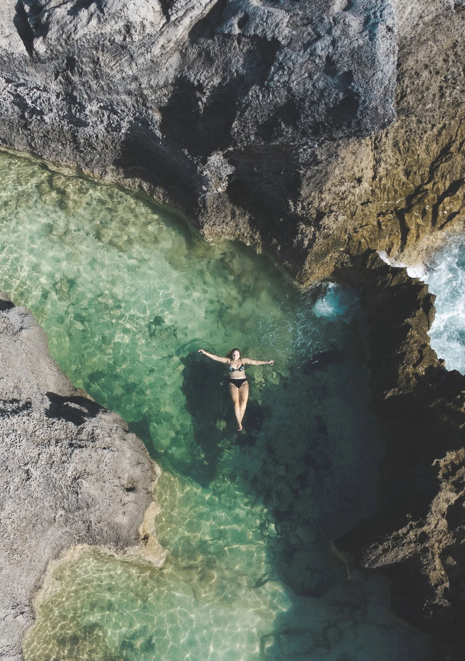 girl floating in hamilton princess bermuda rock pools