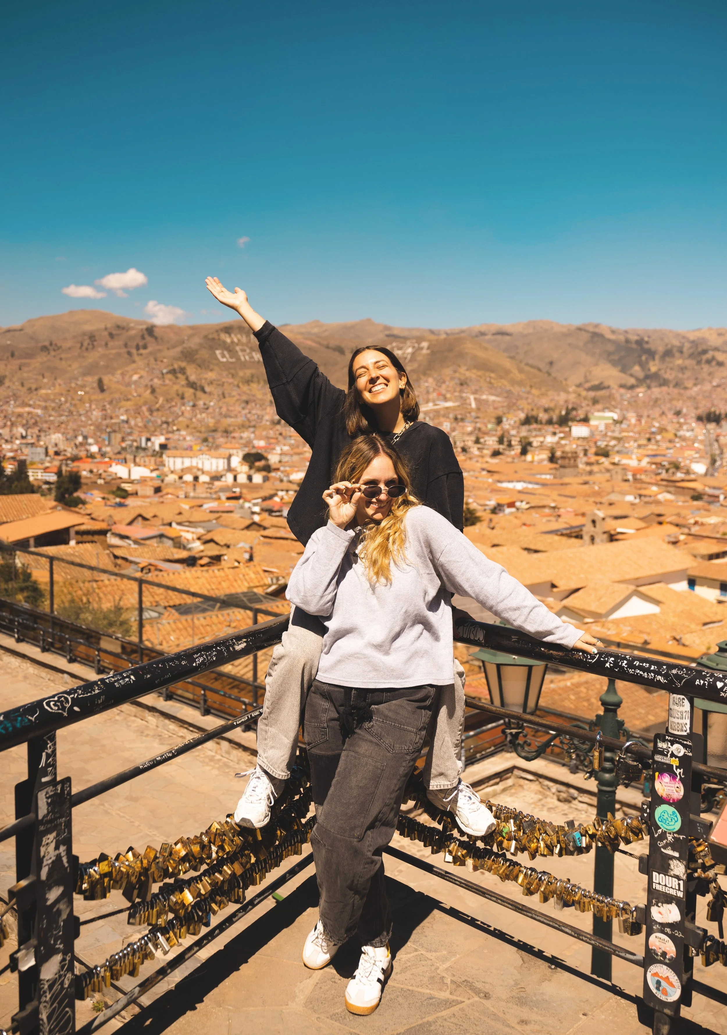 two girls sitting at mirador de san blas lookout point
