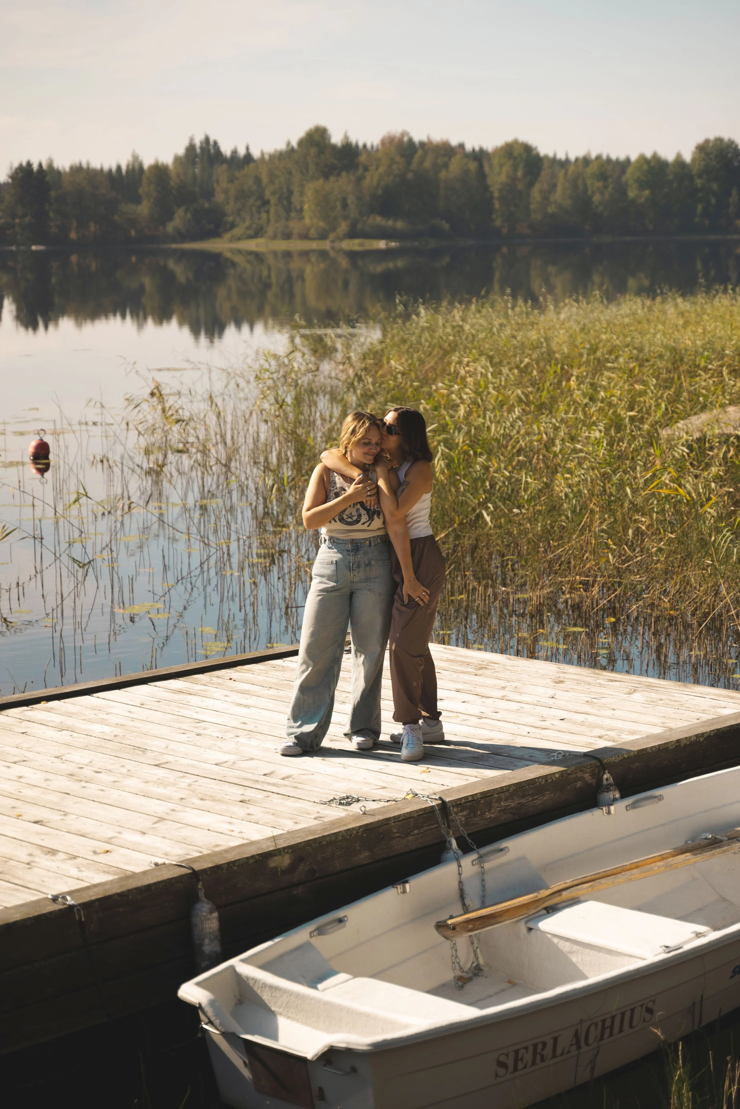 two girls standing on a lakeside dock tampere finland