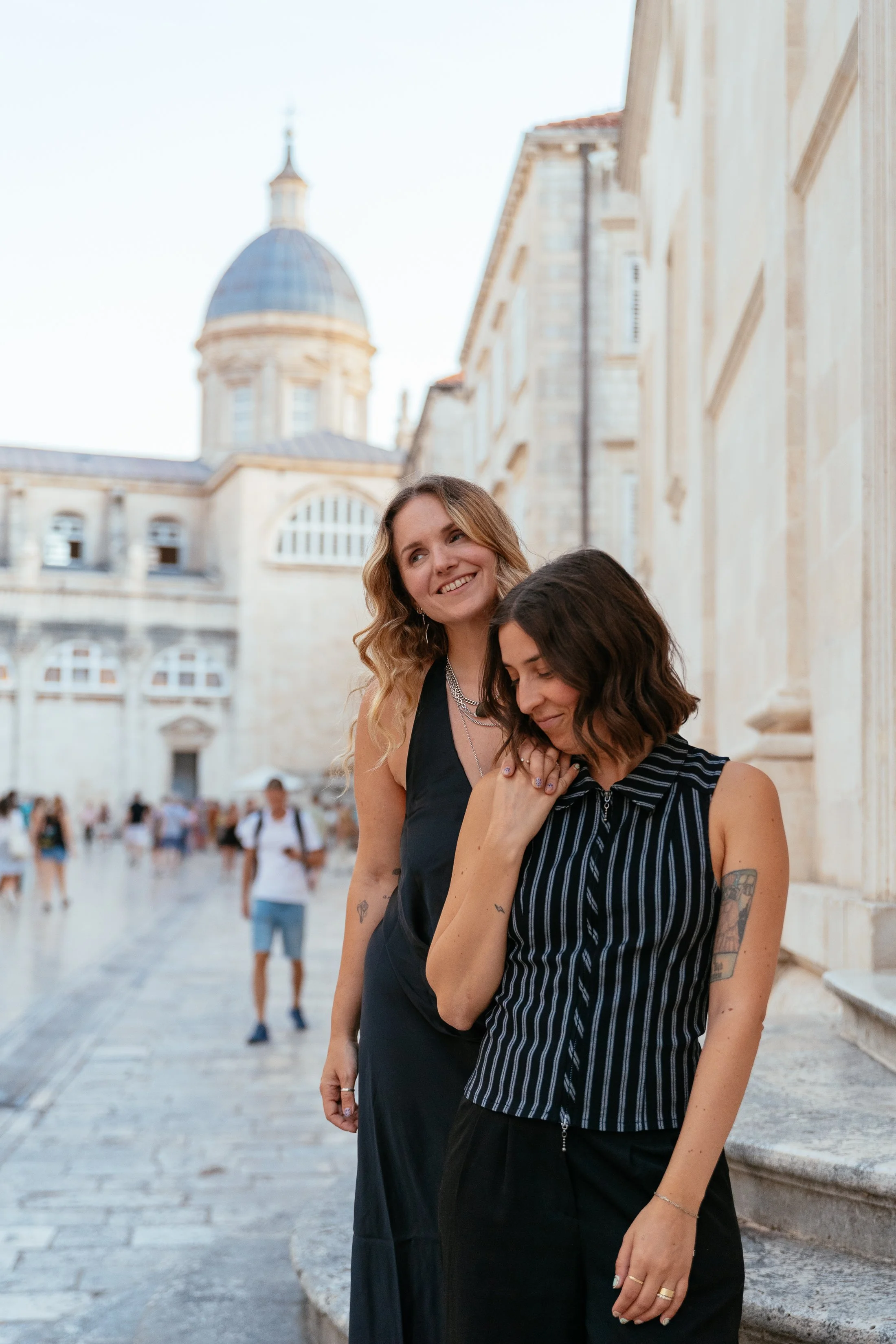 two girls holding hands in old town dubrovnik at sunset