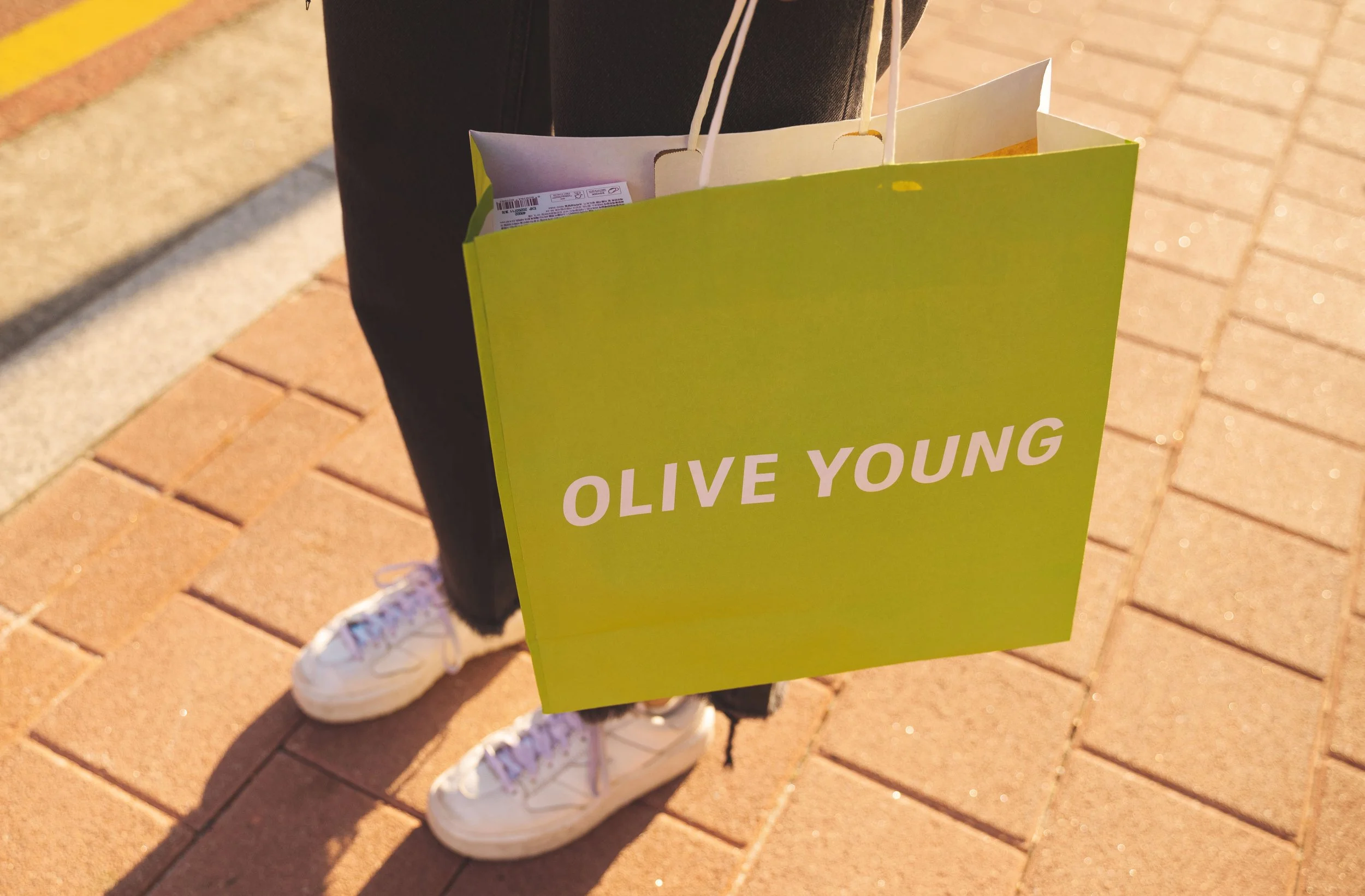girl holding olive young shopping bag seoul