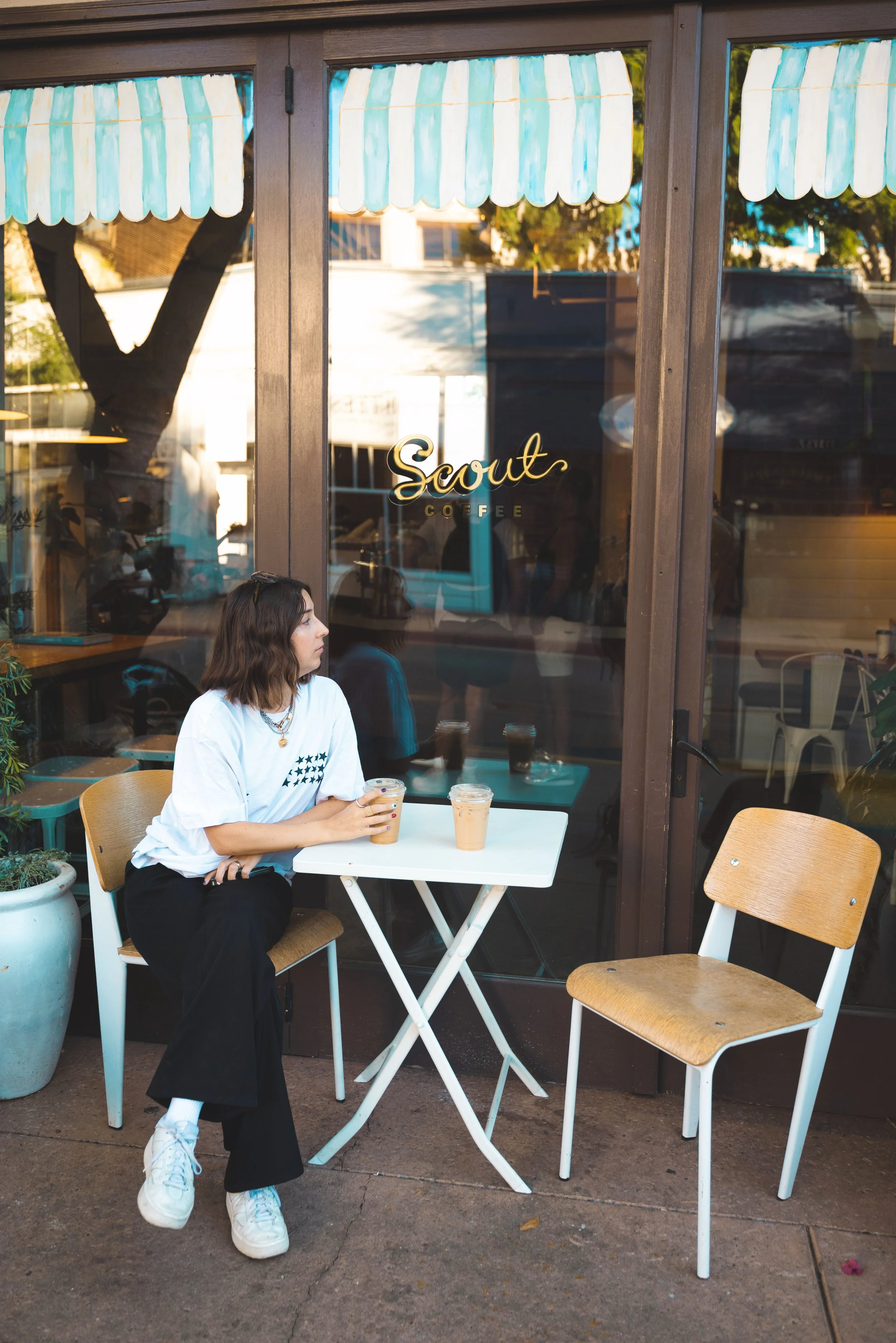 girl sitting outside scout coffee san luis obispo