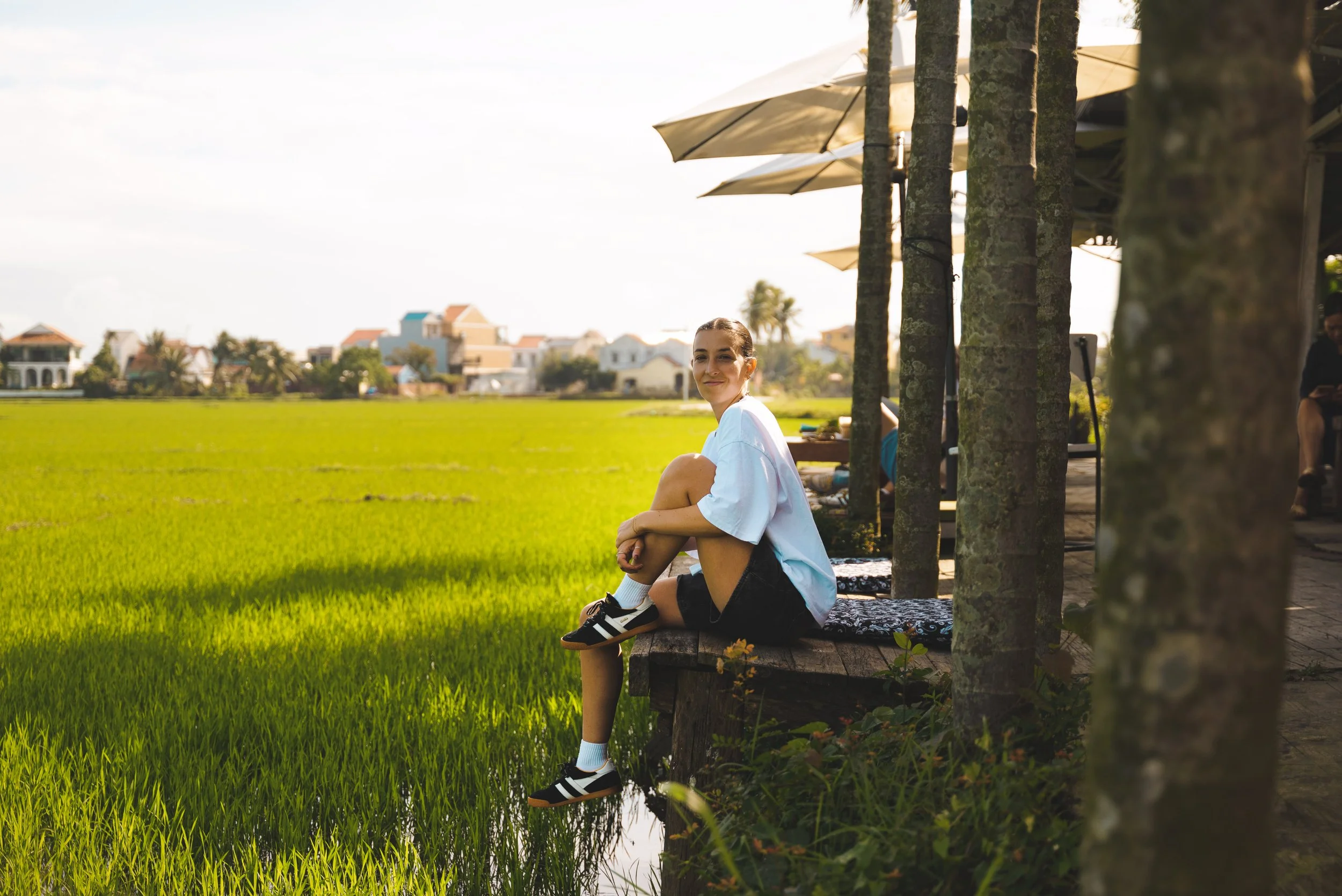 girl sitting at roving chillhouse hoi an looking at rice paddy field