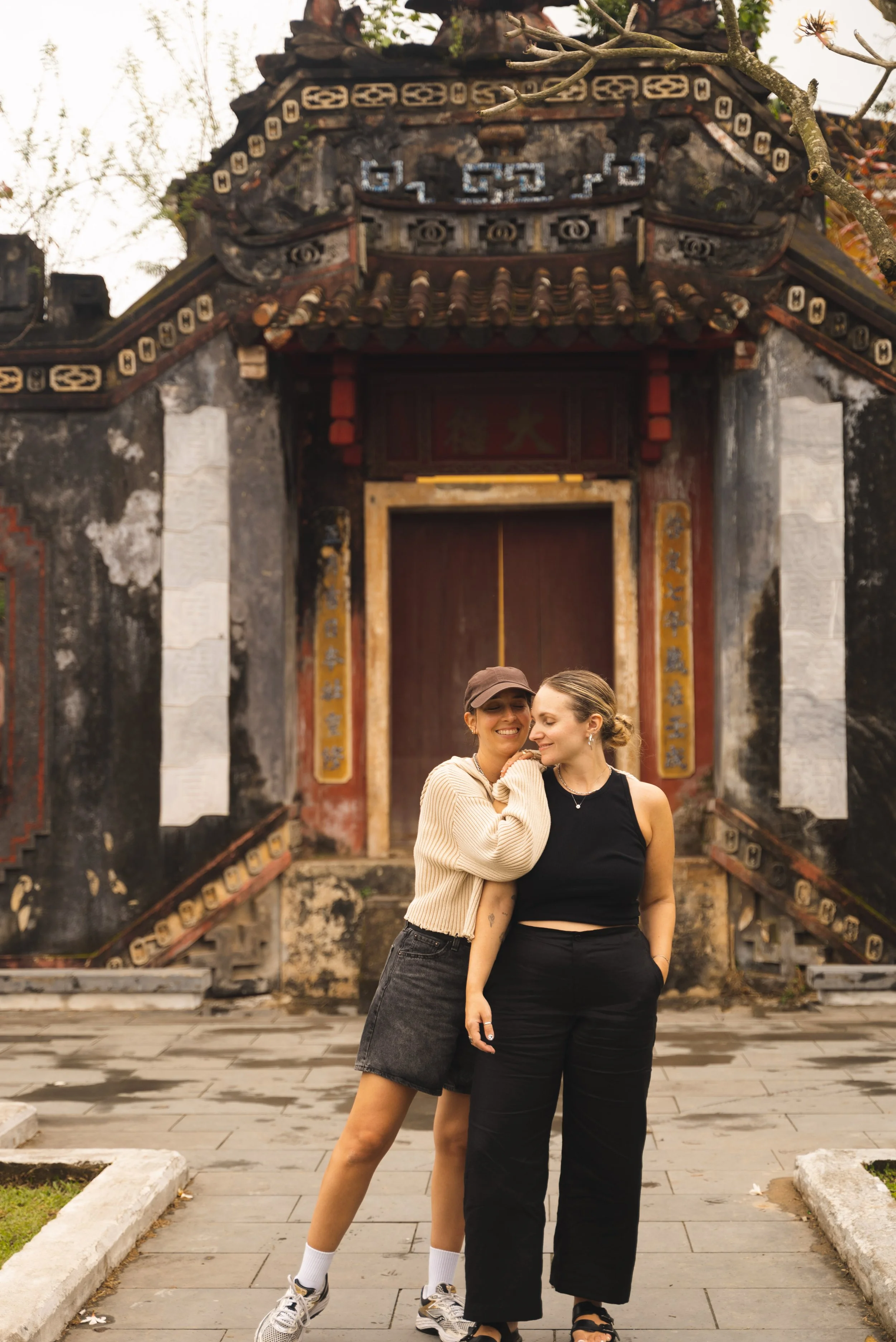 two girls standing in front of temple gates hoi an