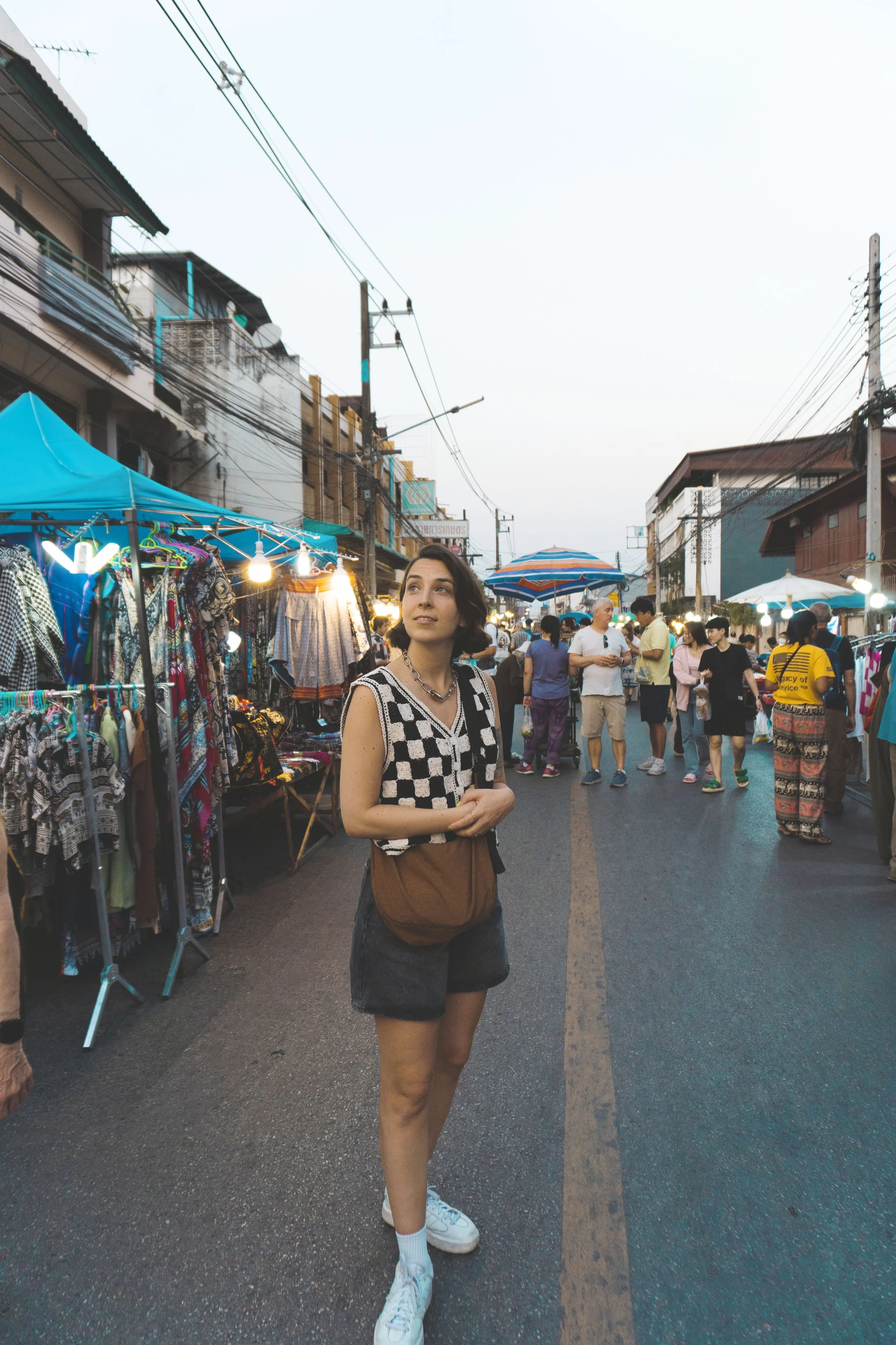 girl standing in middle of chiang mai night market
