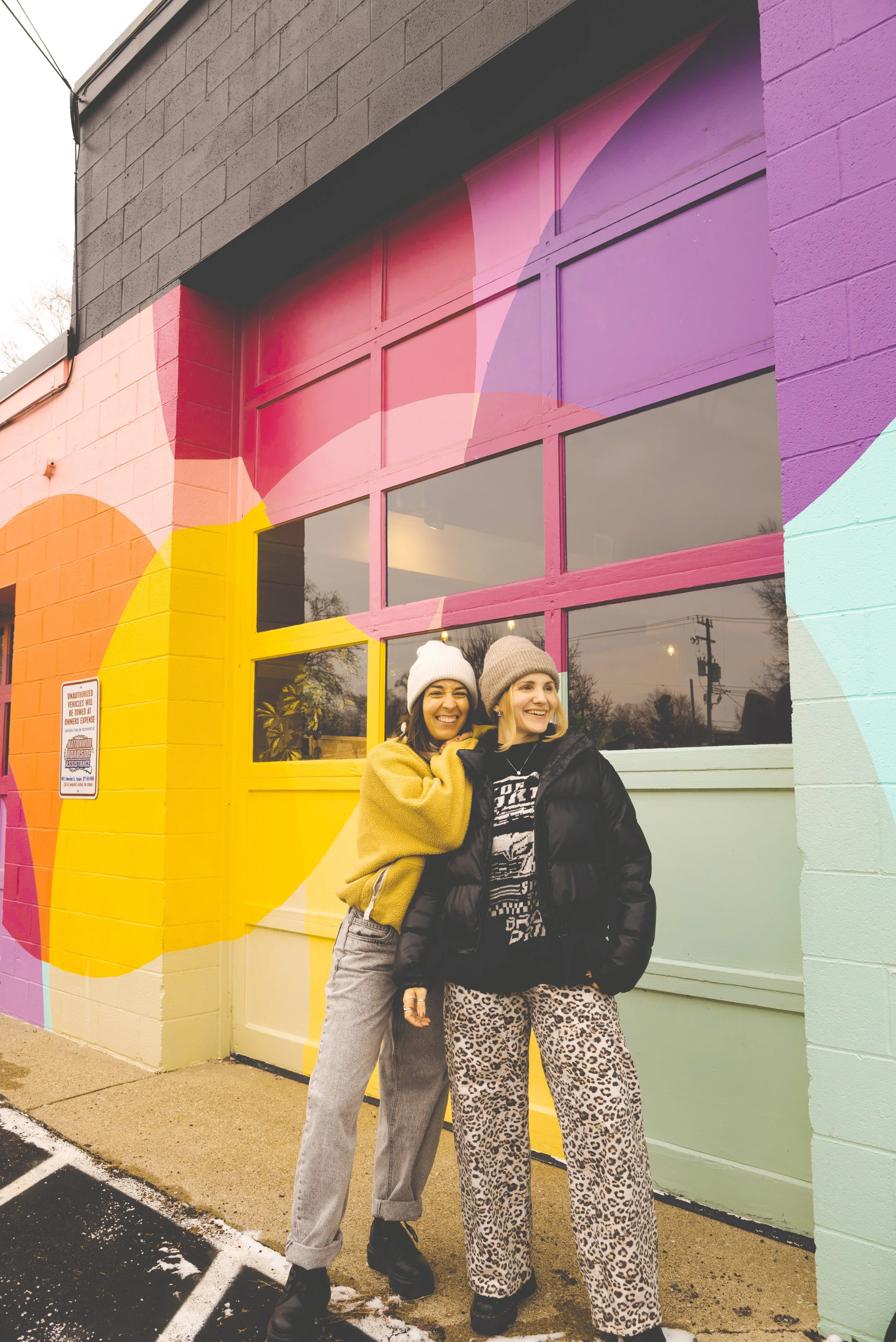 two girls standing in front of rainbow garagde at vertex coffee ypsilanti