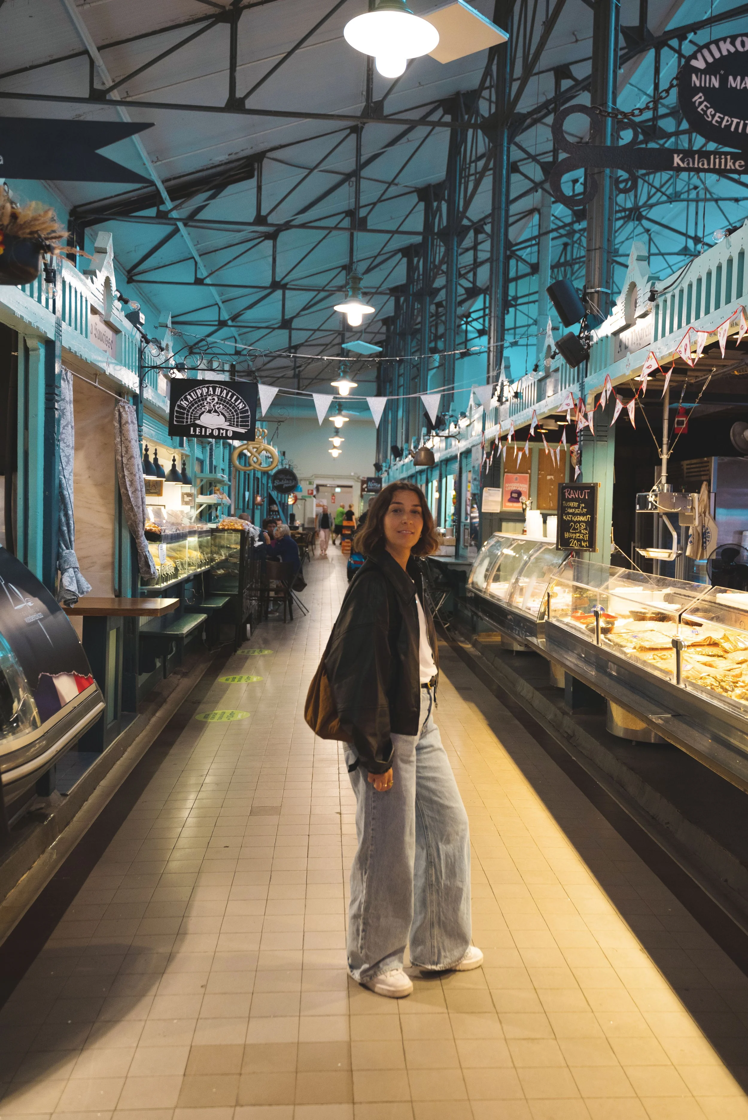 girl walking through tampere market hall finland