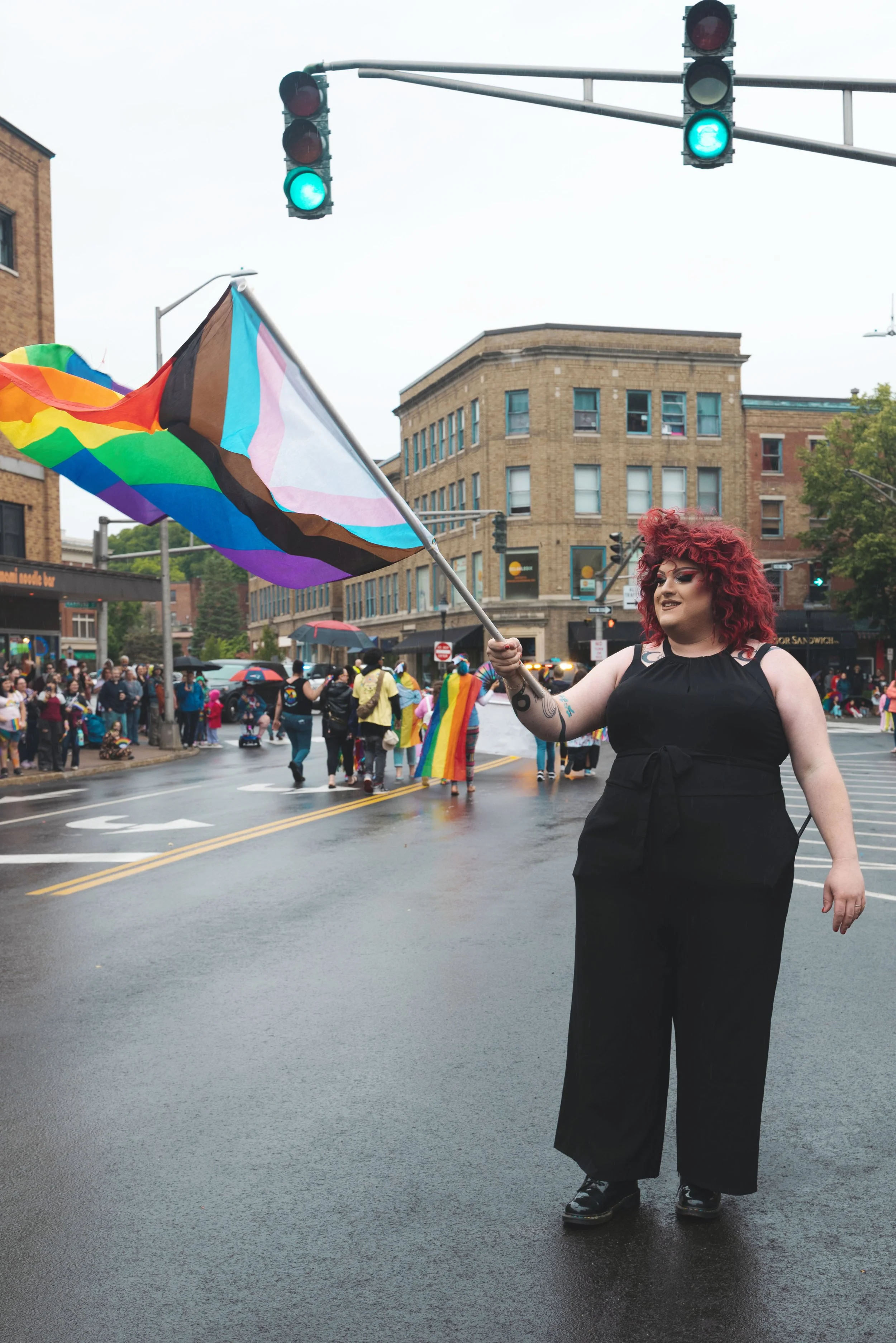person holding pride flag at bangor pride