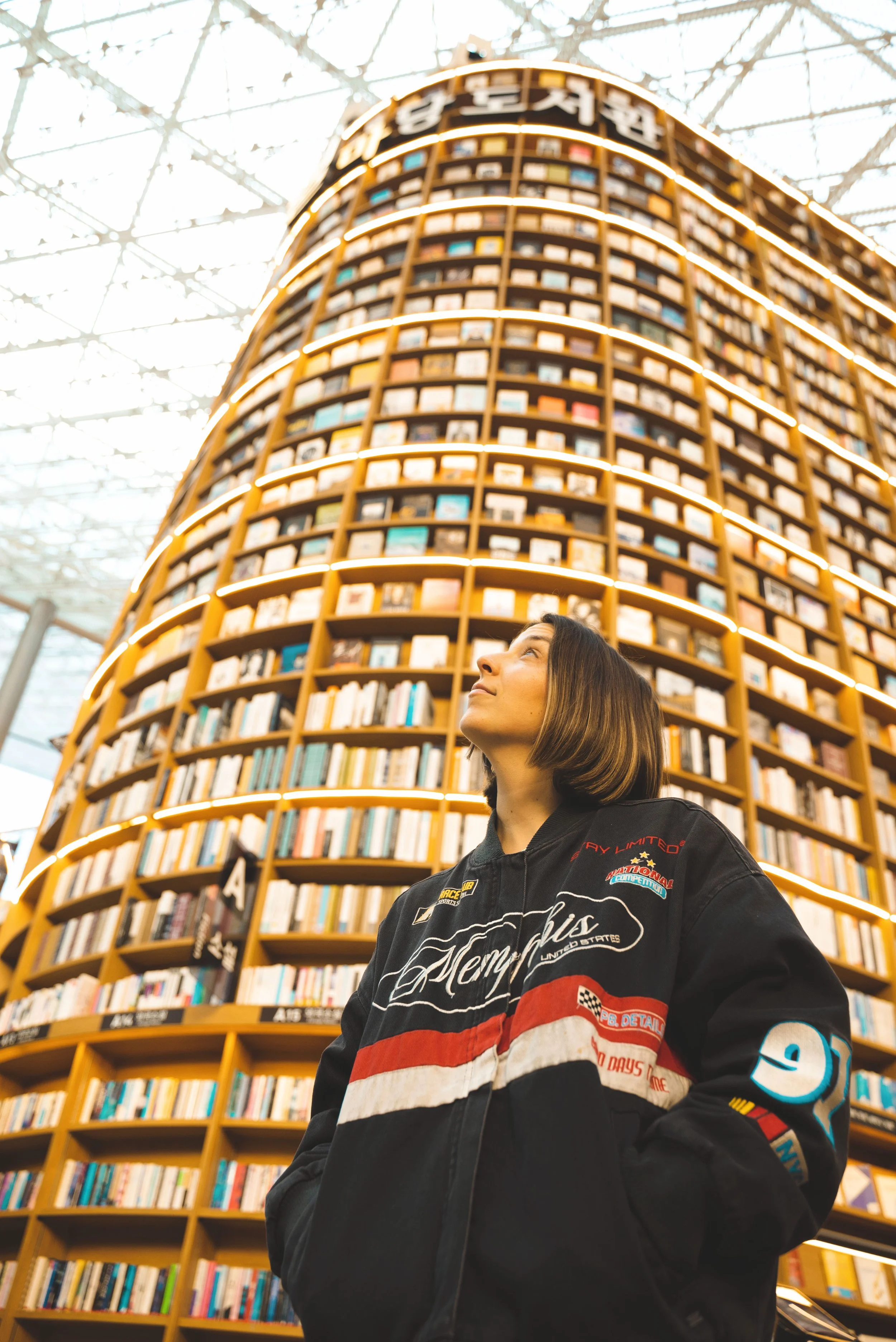 girl looking up at starfield library in coex mall seoul
