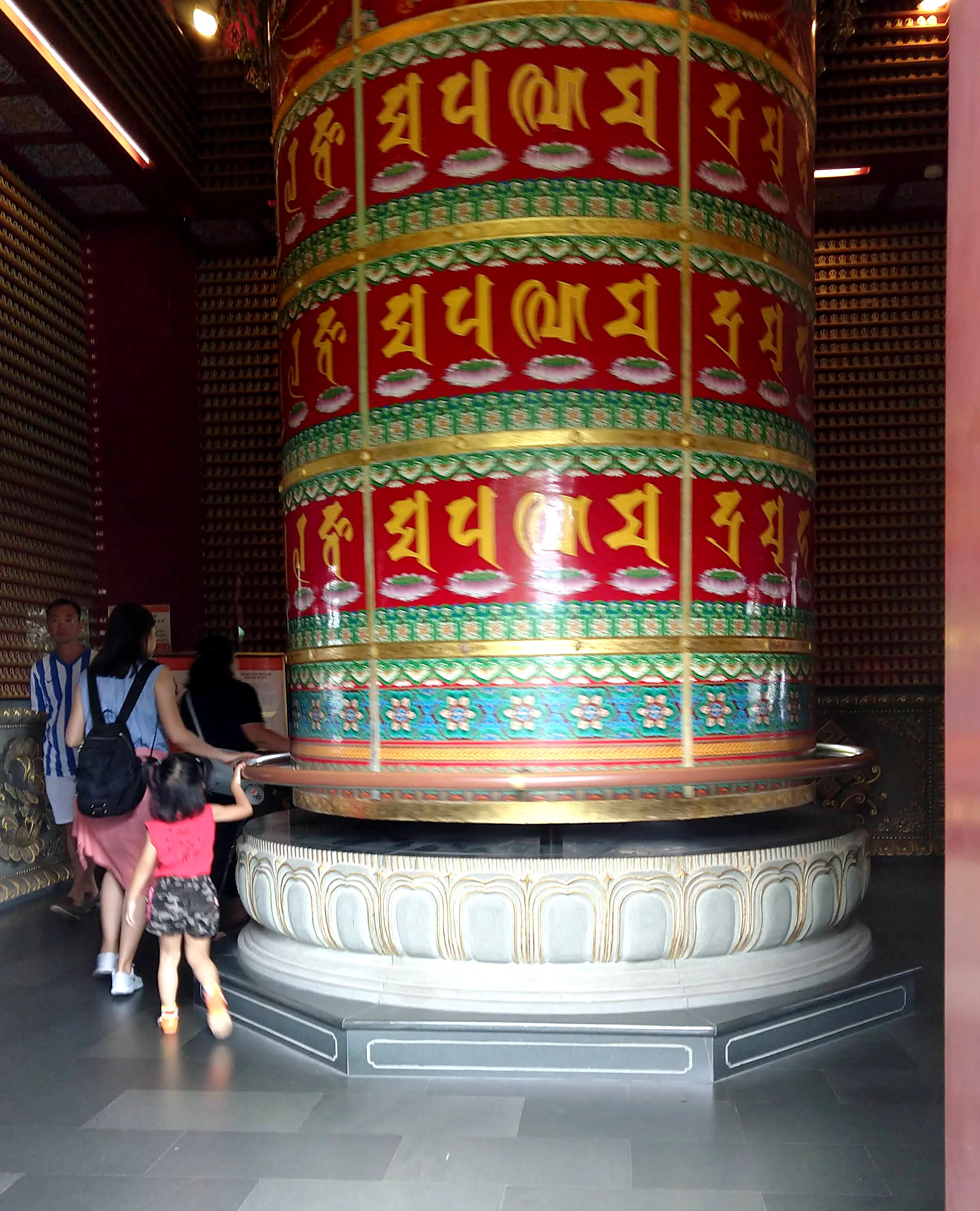 The largest cloisonné prayer wheel in the world, at the Buddha Tooth Relic Temple in Singapore. You hold onto a handrail to turn it.