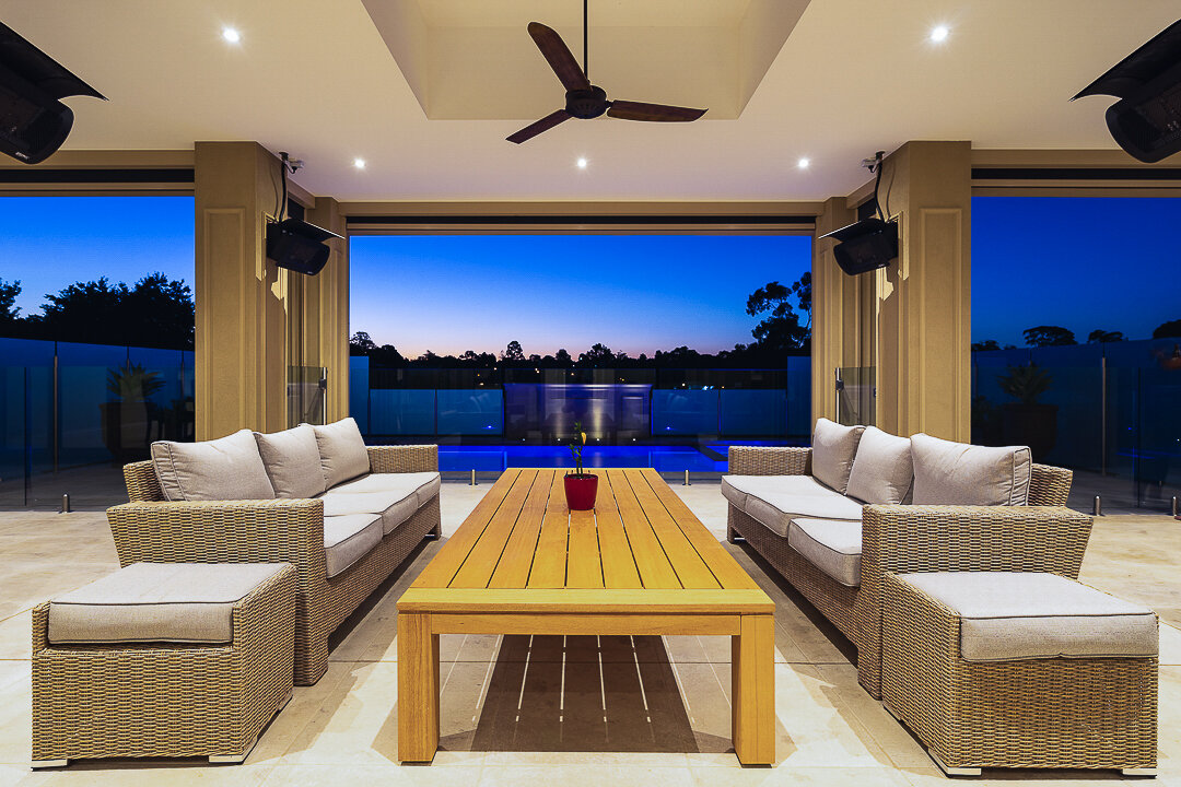 Home interior photo looking out to pool at dusk in Melbourne.