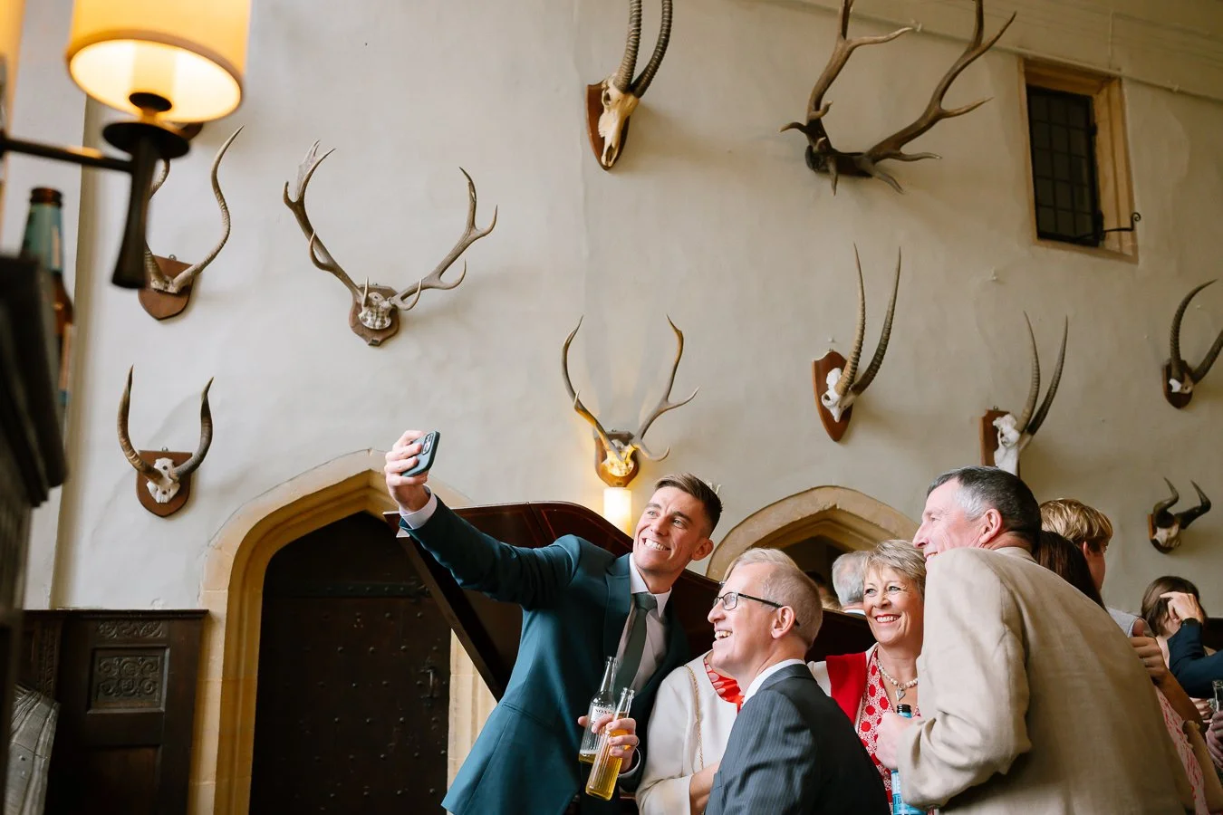Guests at a wedding taking a picture of themselves 