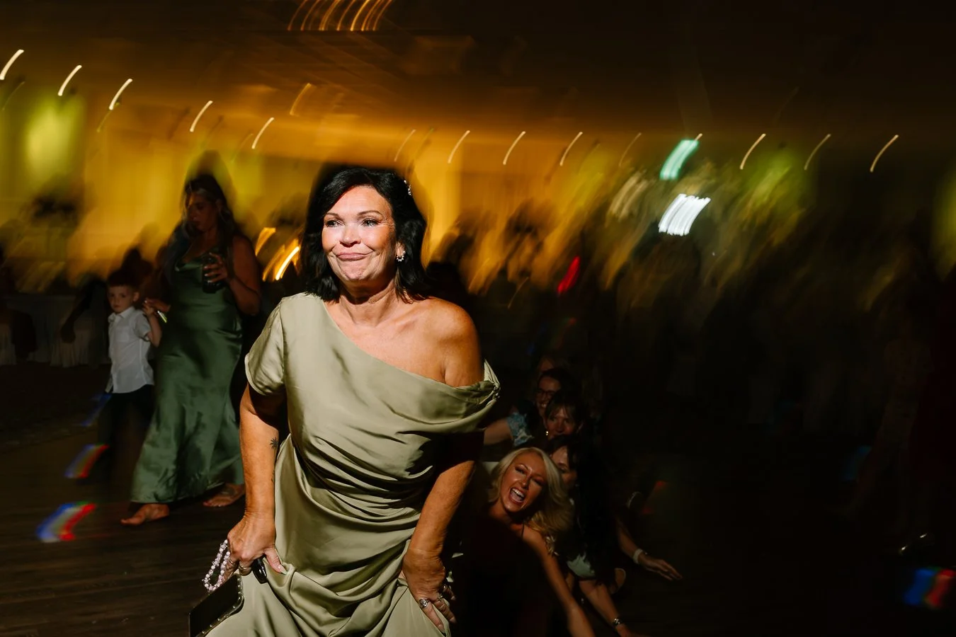 Dancing, pulling a face at a wedding reception 