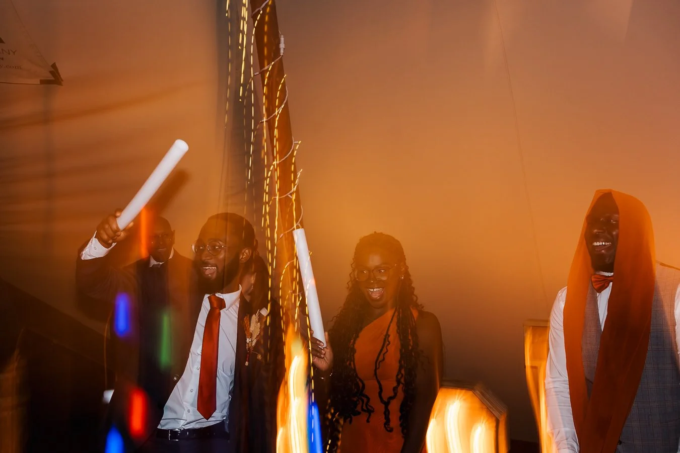 Guests dancing and smiling at a wedding party 