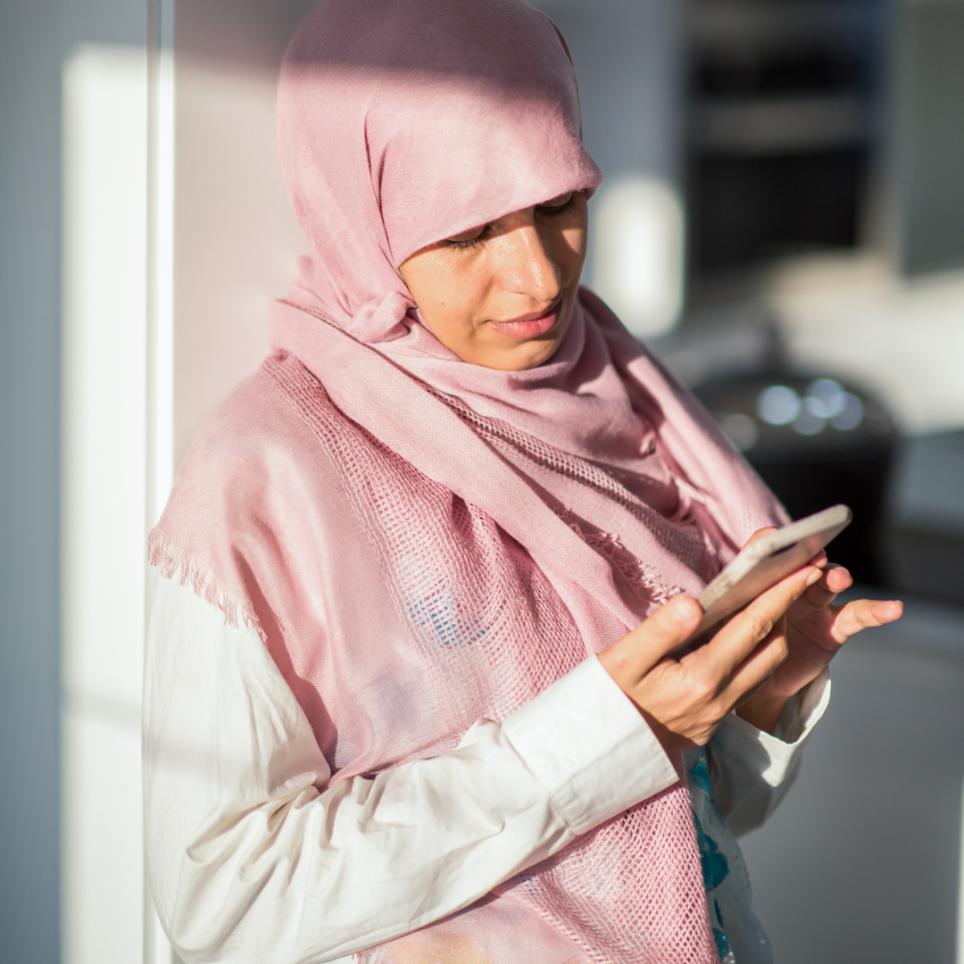 ViDe muslim woman holding phone website image.png